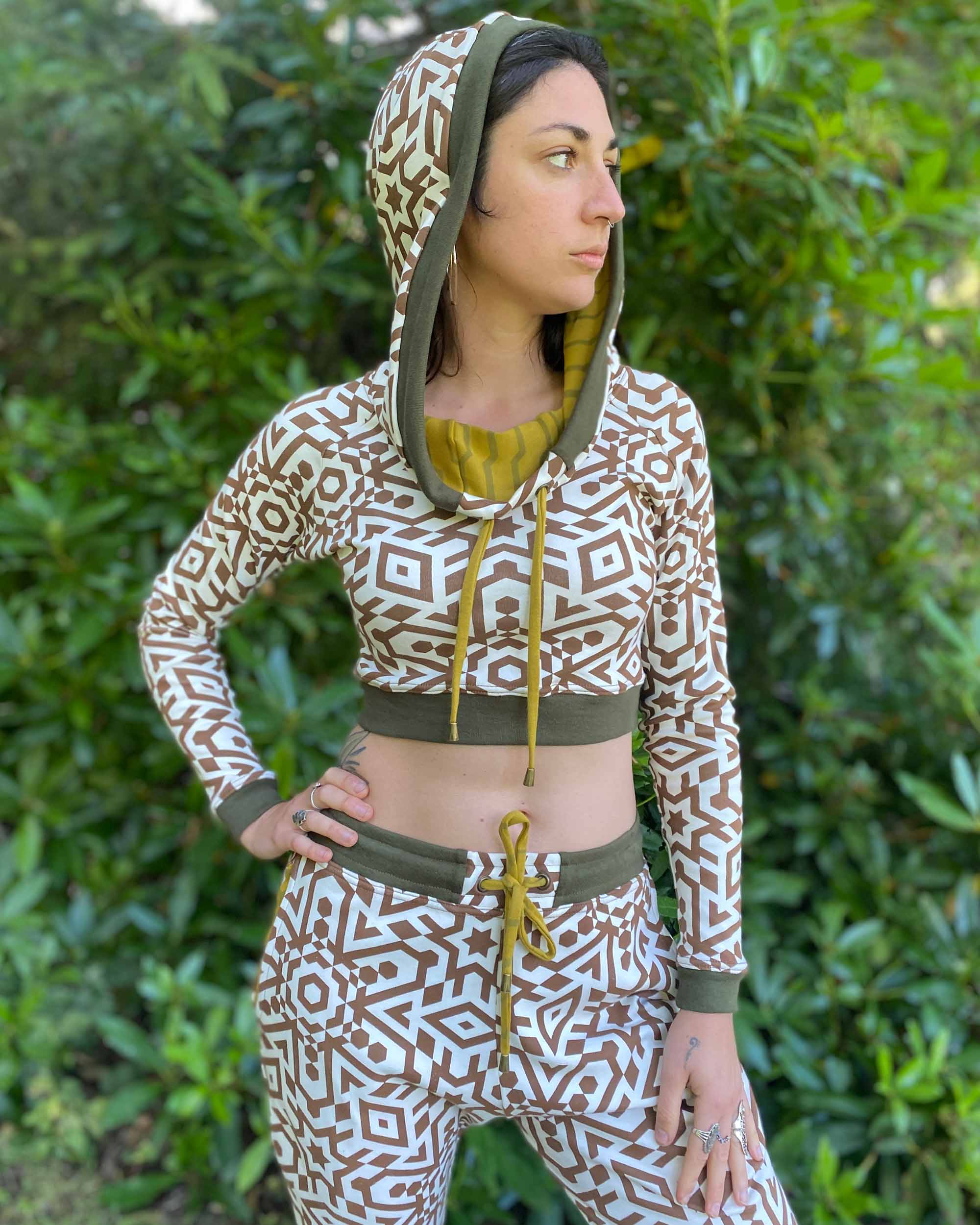 Matching two piece set, joggers and crop hoodie, undyed fabric with brown geometric print, front view on model.