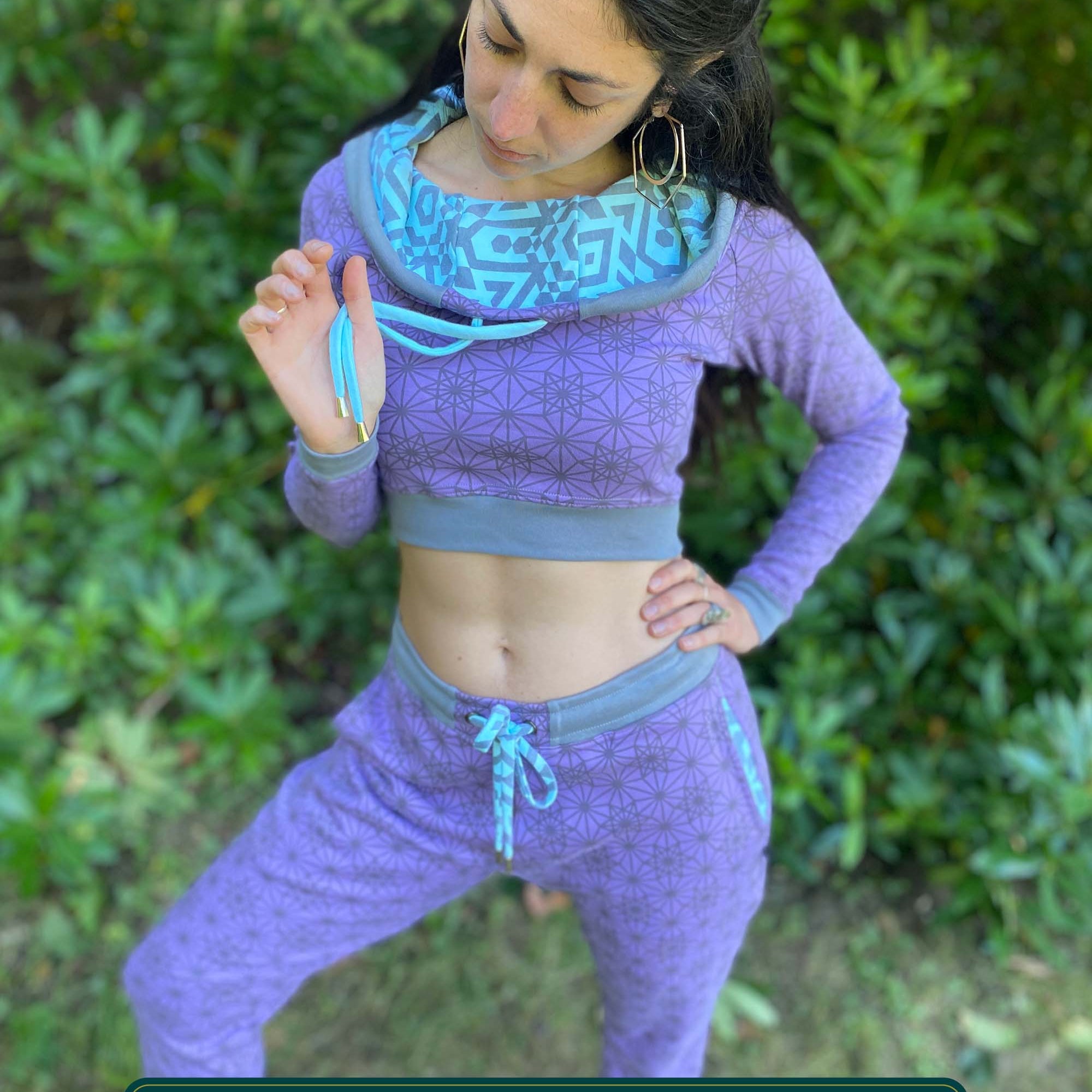 Matching two piece set, joggers and crop hoodie, lavender with geometric printed fabric, worn on female model.