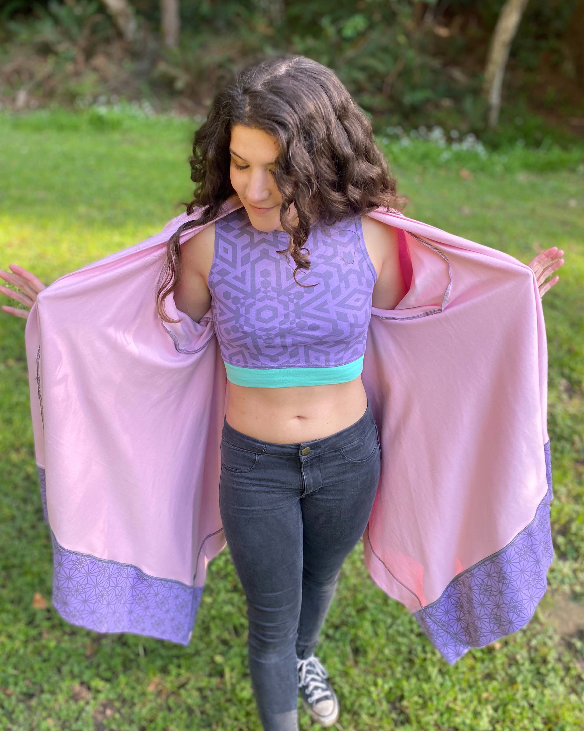 Organic cotton crop top, lavender fabric with sacred geometry print, front view in natural lighting.