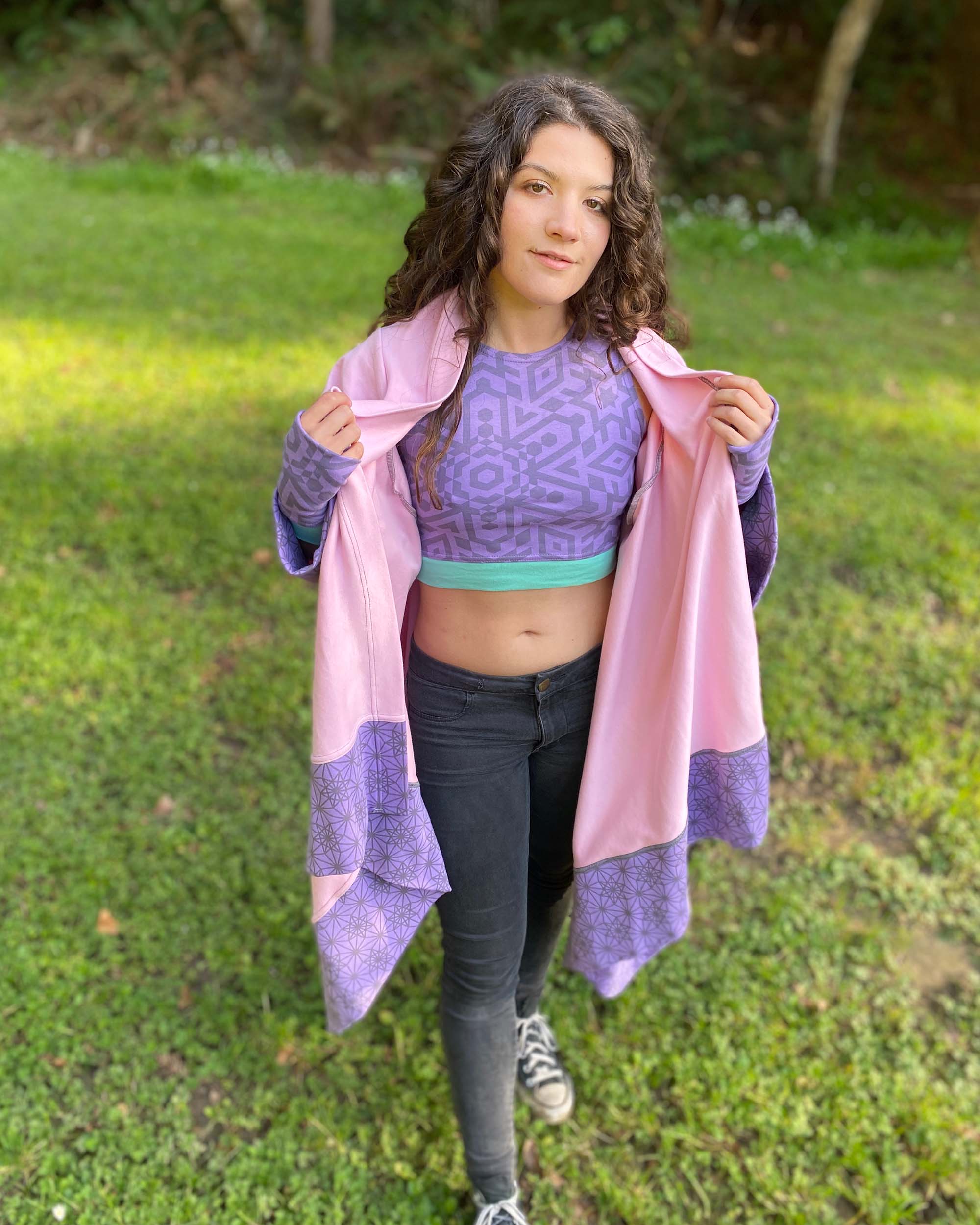 Organic cotton crop top, lavender fabric with sacred geometry print and pink kimono, front view on female model.