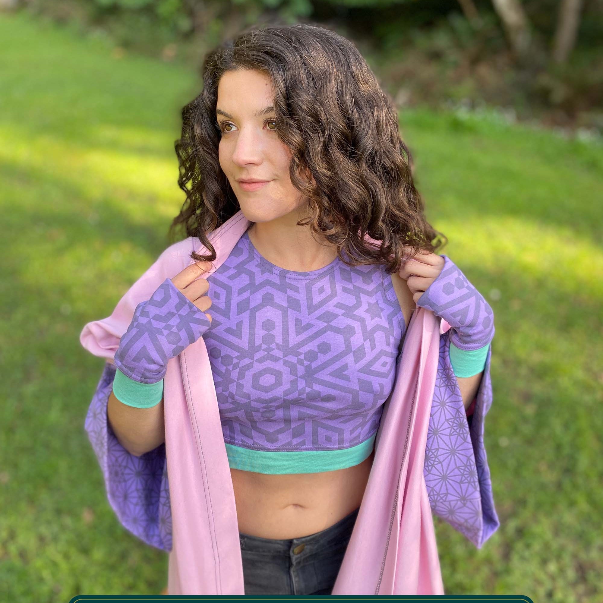 Organic cotton crop top, lavender fabric with sacred geometry print, front view on female model.