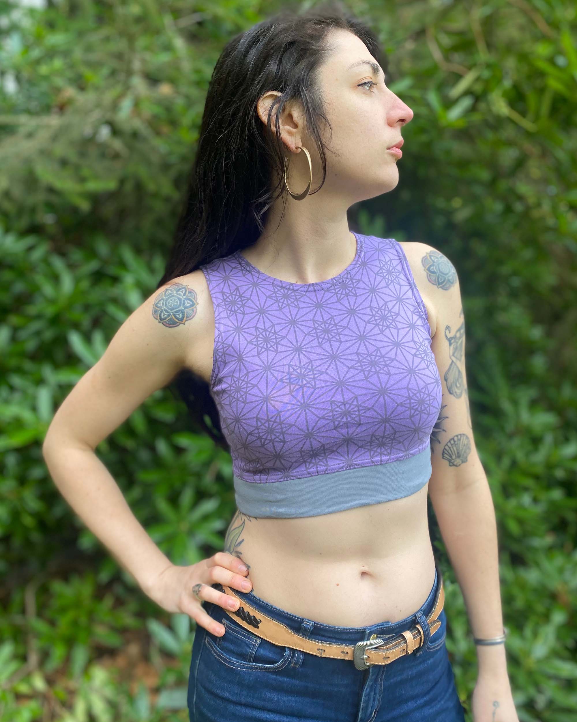 Organic cotton crop top, lavender fabric with sacred geometry print, front right side view on female model.