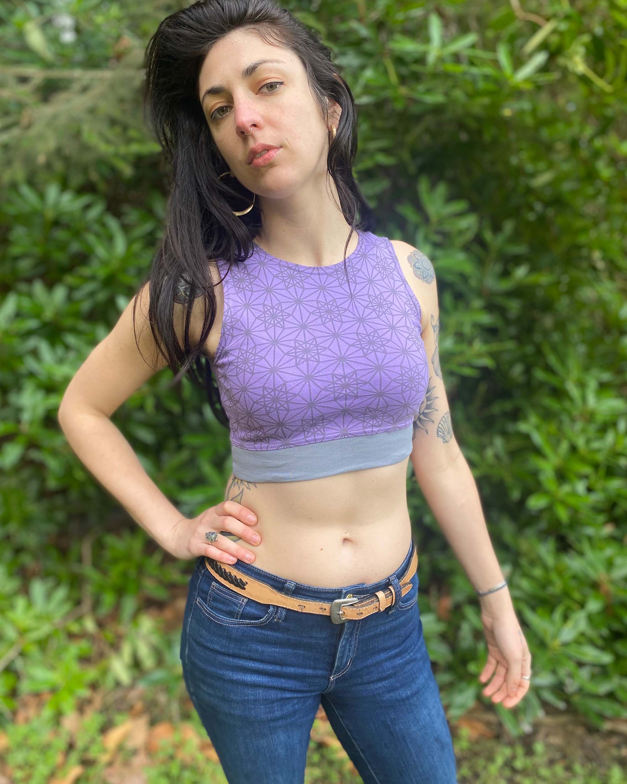 Organic cotton crop top, lavender fabric with sacred geometry print, front view on tall female model.