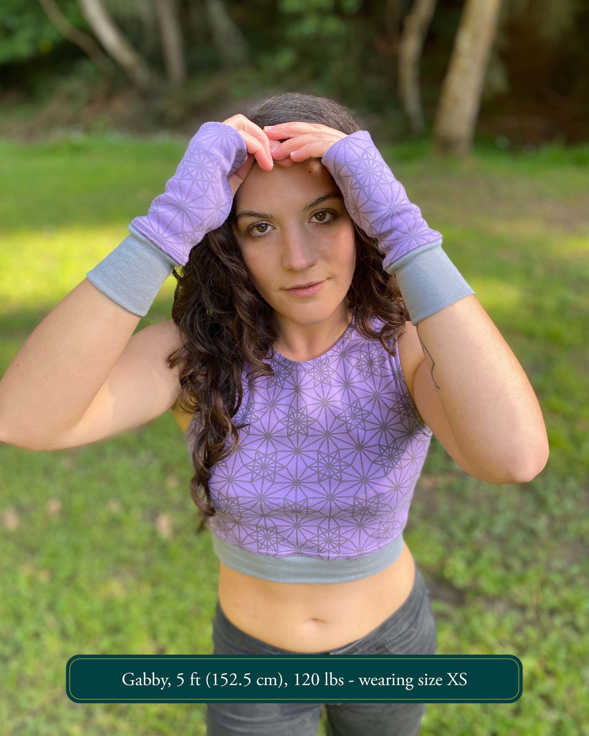 Organic cotton crop top, lavender fabric with sacred geometry print, front view on female model.