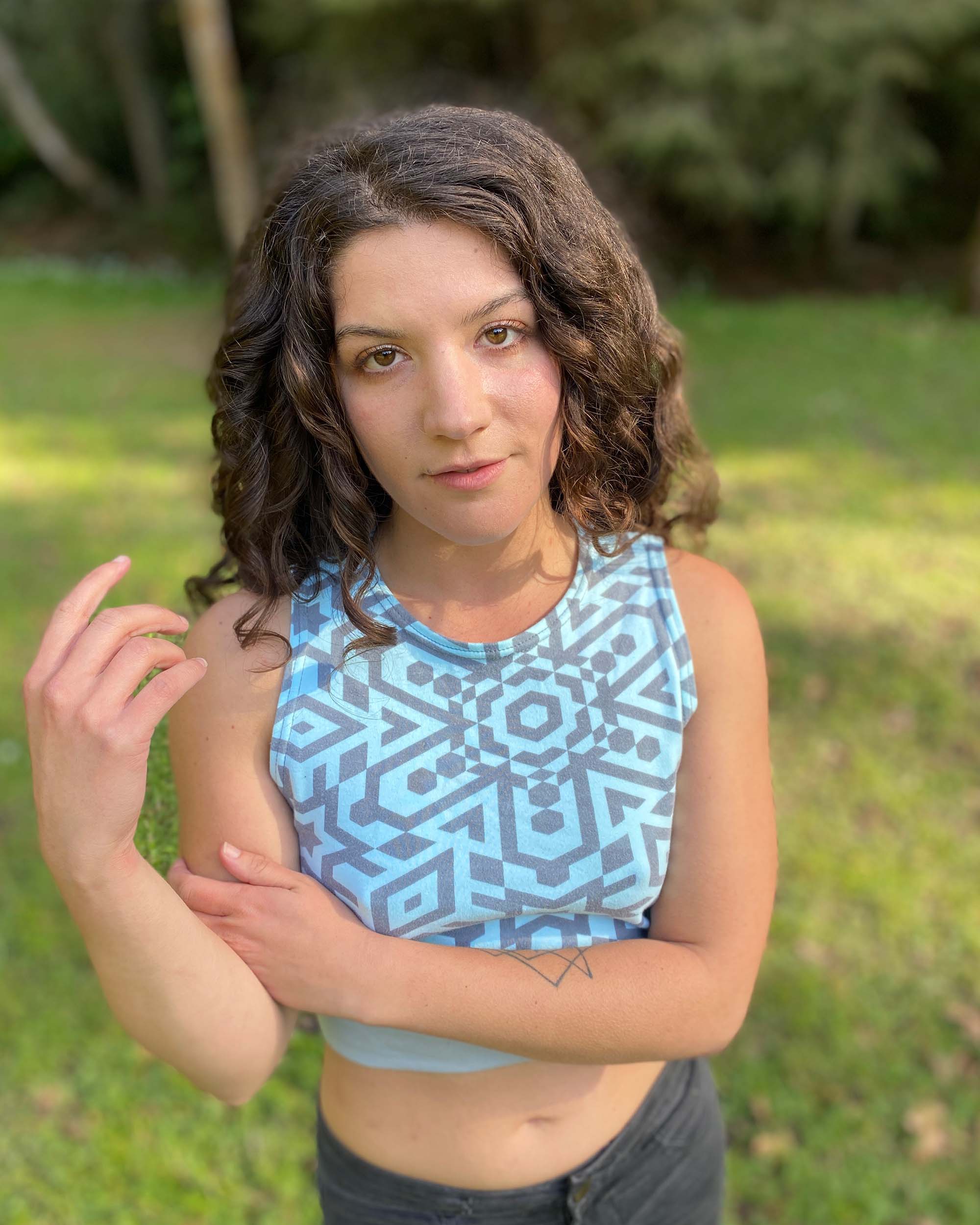 Organic cotton crop top, mint colored fabric with grey geometric print, front close up.