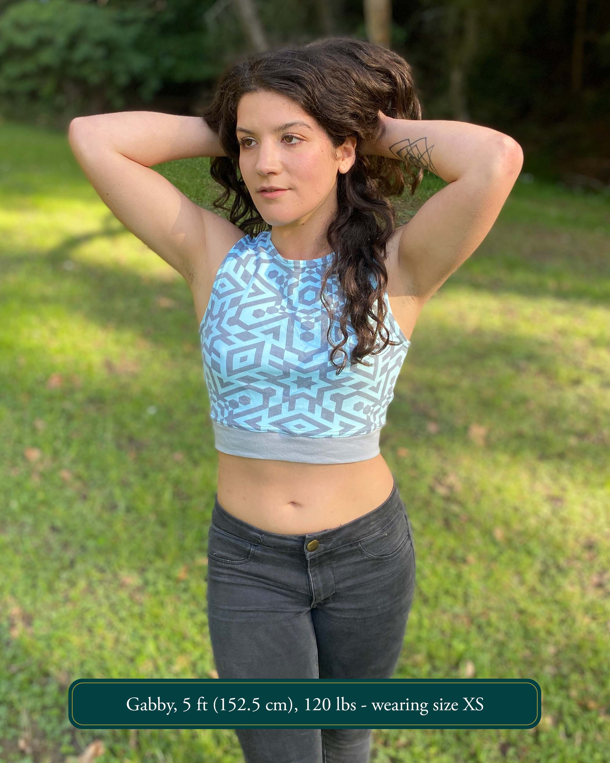 Organic cotton crop top, mint colored fabric with grey geometric print worn by female model in nature.