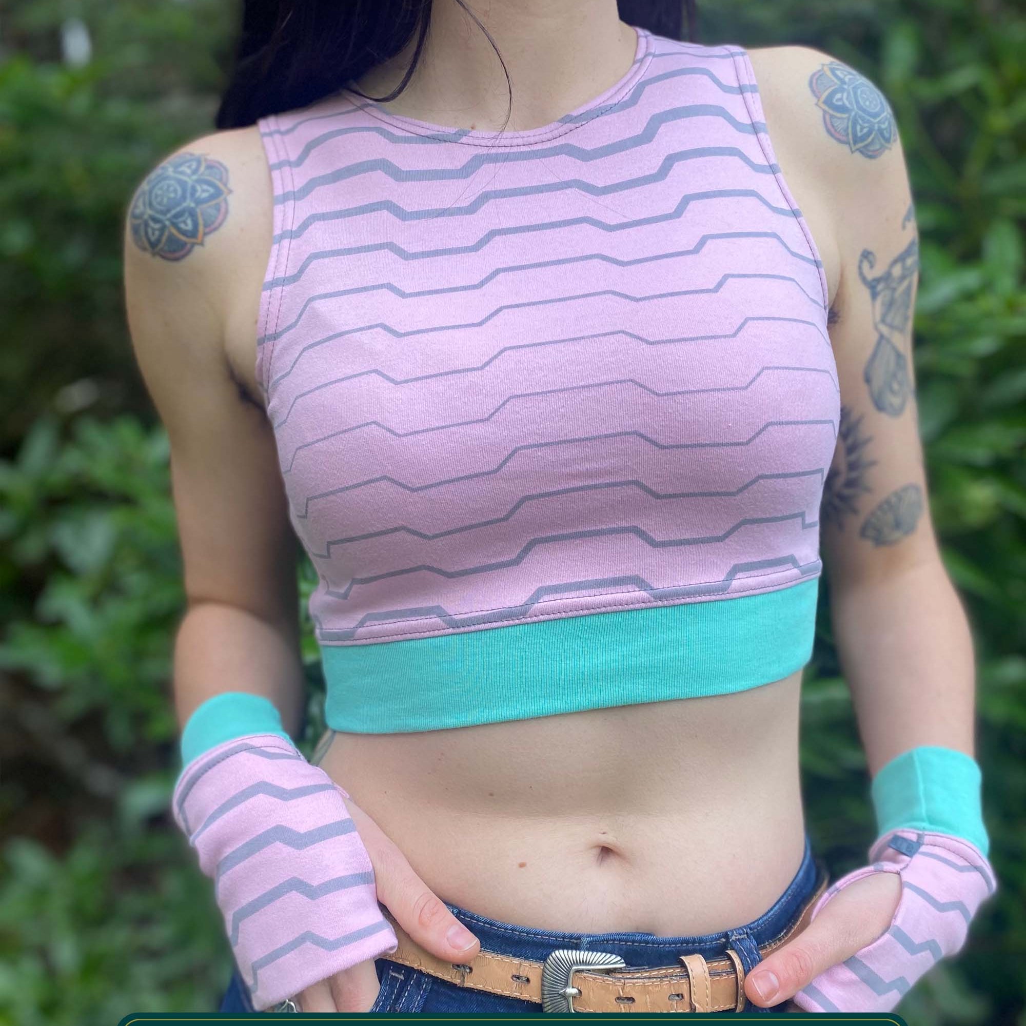 Organic cotton crop top, pink fabric with grey geometric print, front view on model.
