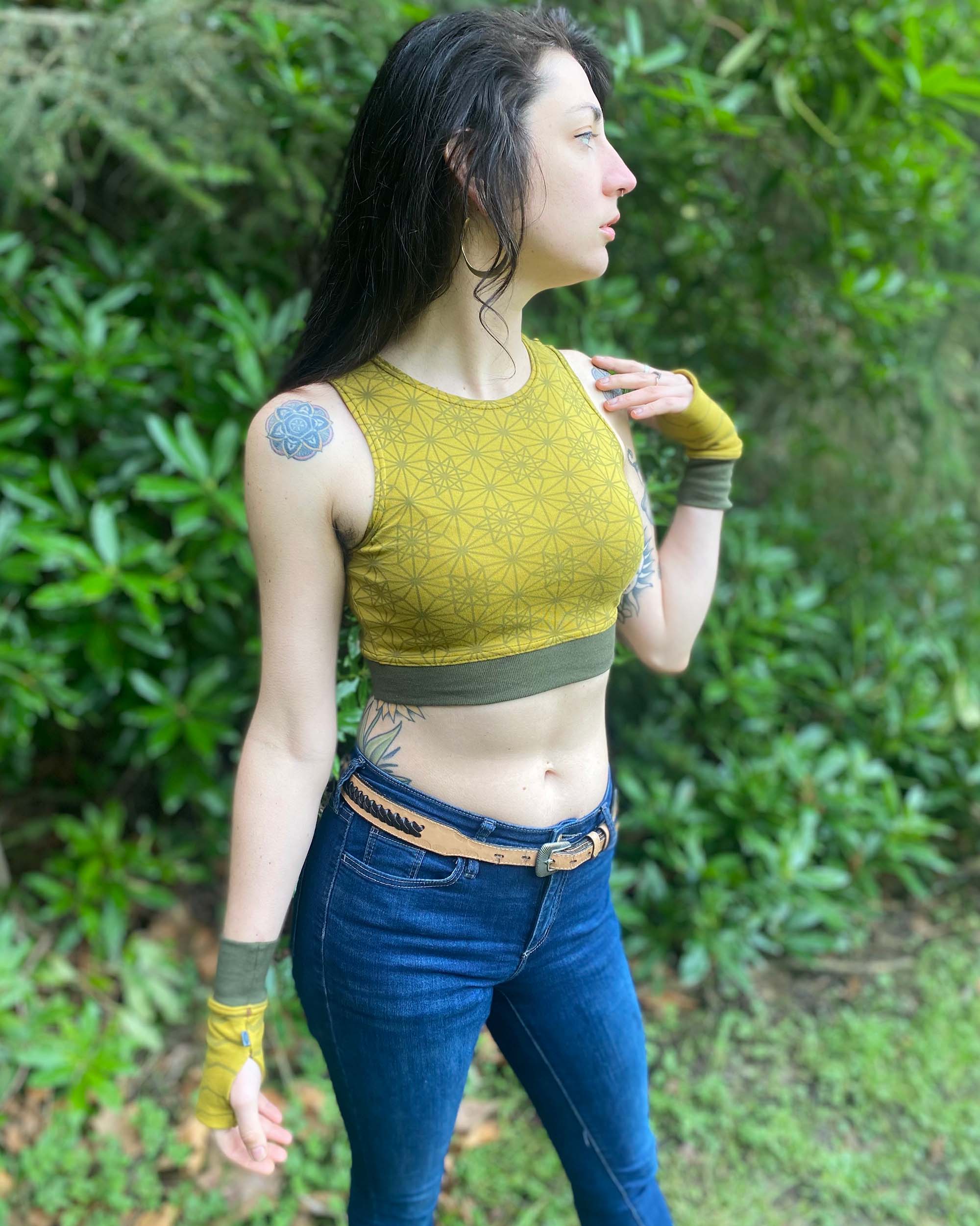 Organic cotton crop top, yellow fabric with sacred geometry print and green accent fabric, right side view.