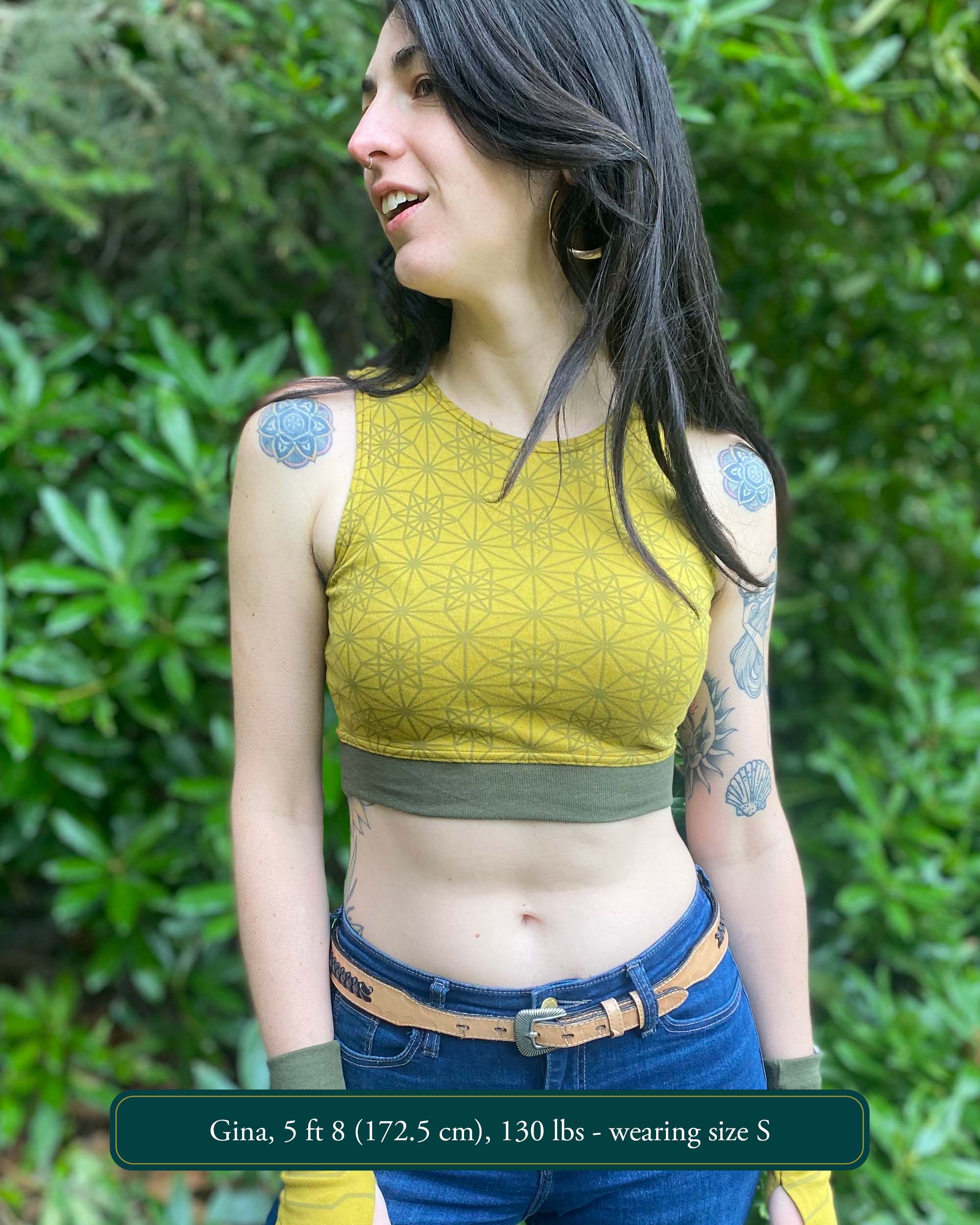 Organic cotton crop top, yellow fabric with sacred geometry print and green accent fabric, front view.