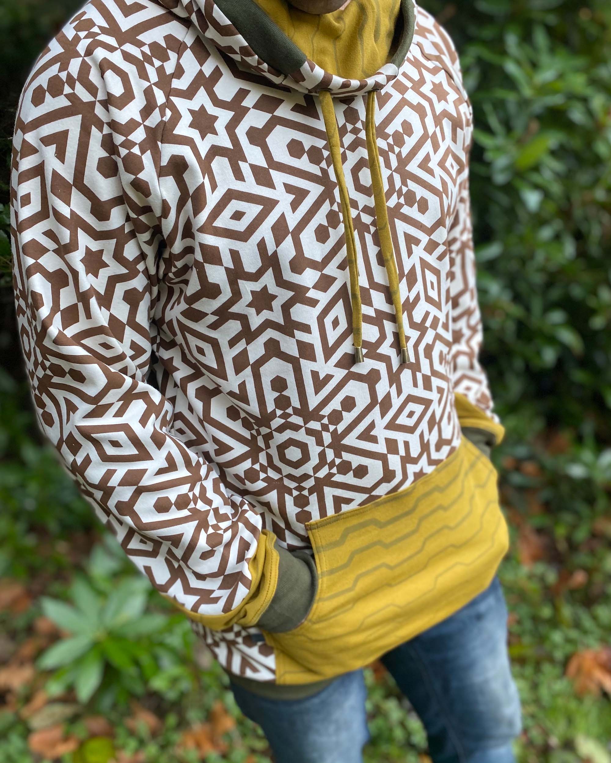Organic cotton hoodie, un-dyed fabric with brown geometric print, detail view of fabric.