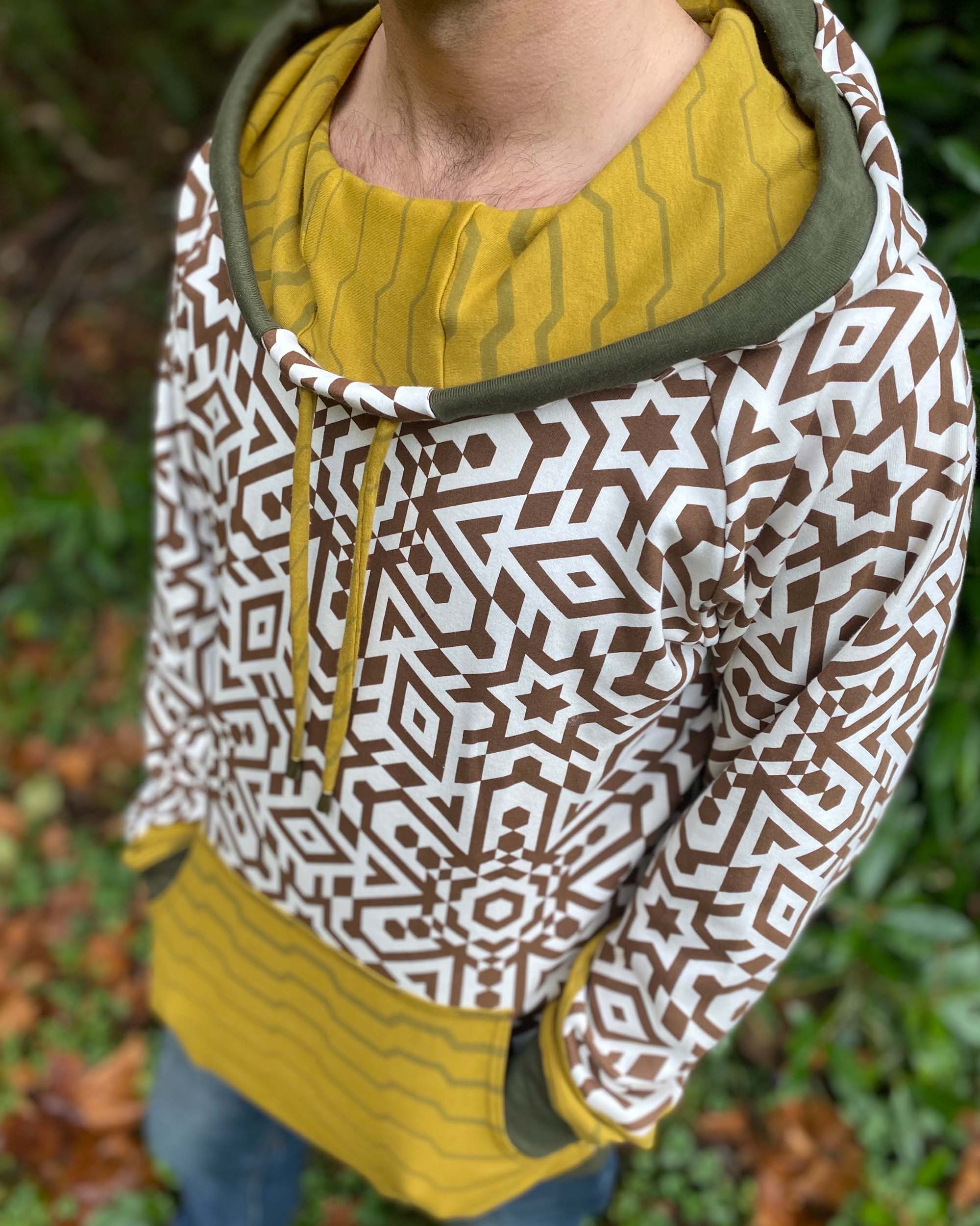 Organic cotton hoodie, un-dyed fabric with brown geo print, detail front view of fabric.