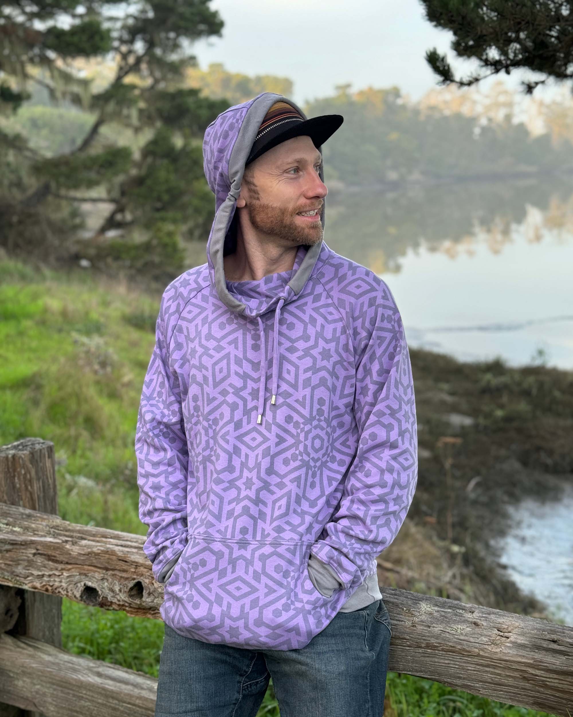 Organic cotton extra long unisex hoodie, lavender with sacred geometry print, front view of male model.
