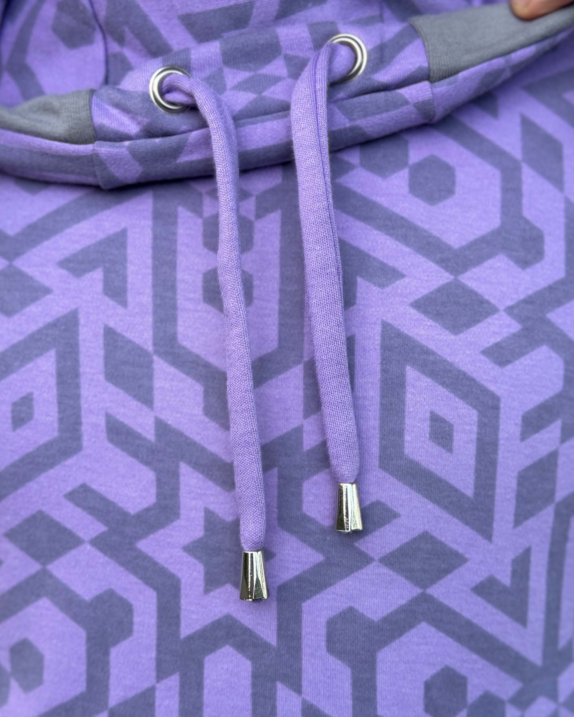 Organic cotton drawcord with brass grommets and brass drawcord end, detail close up view.