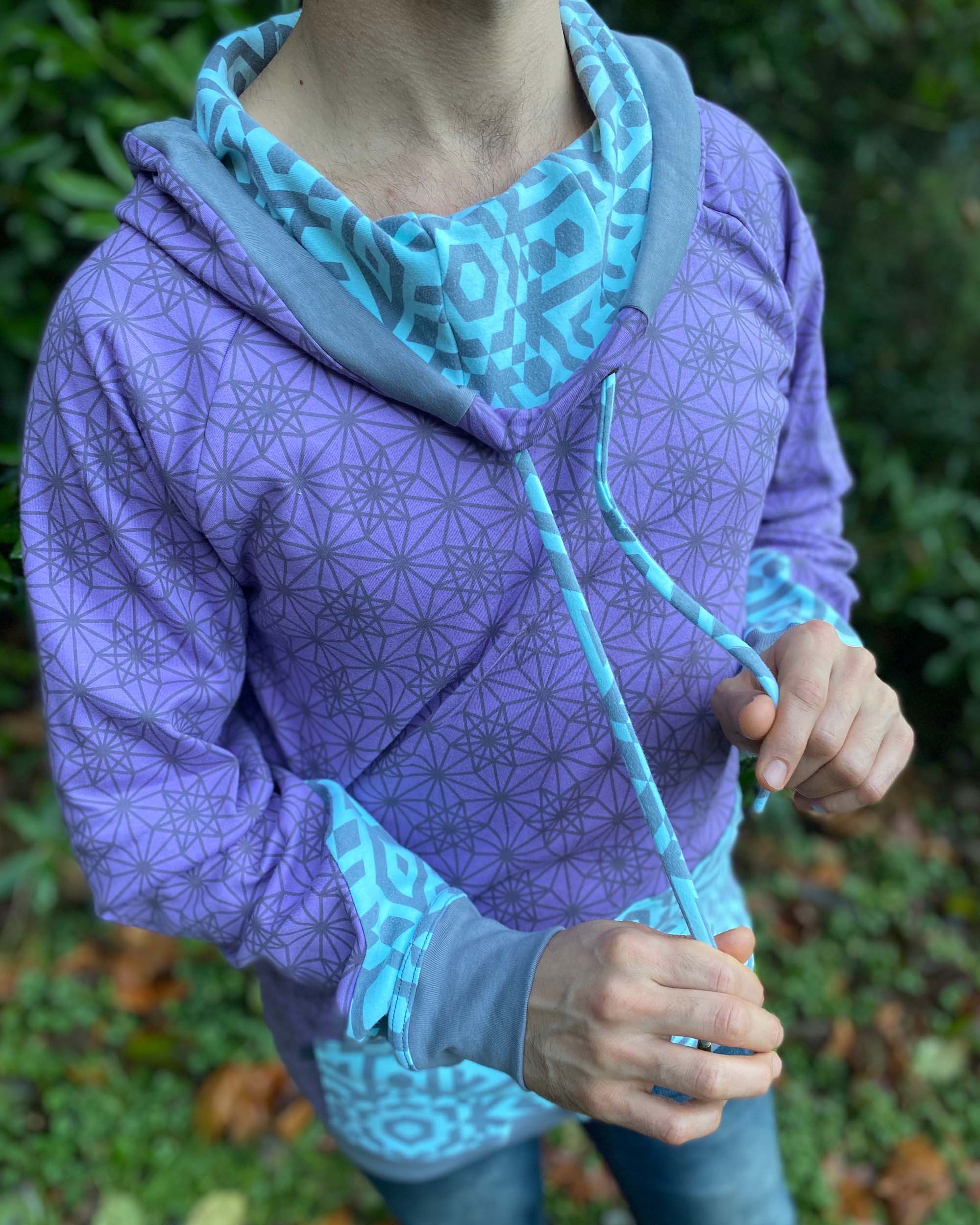 Organic cotton hoodie, lavender fabric with geo print, detail view of drawcords.