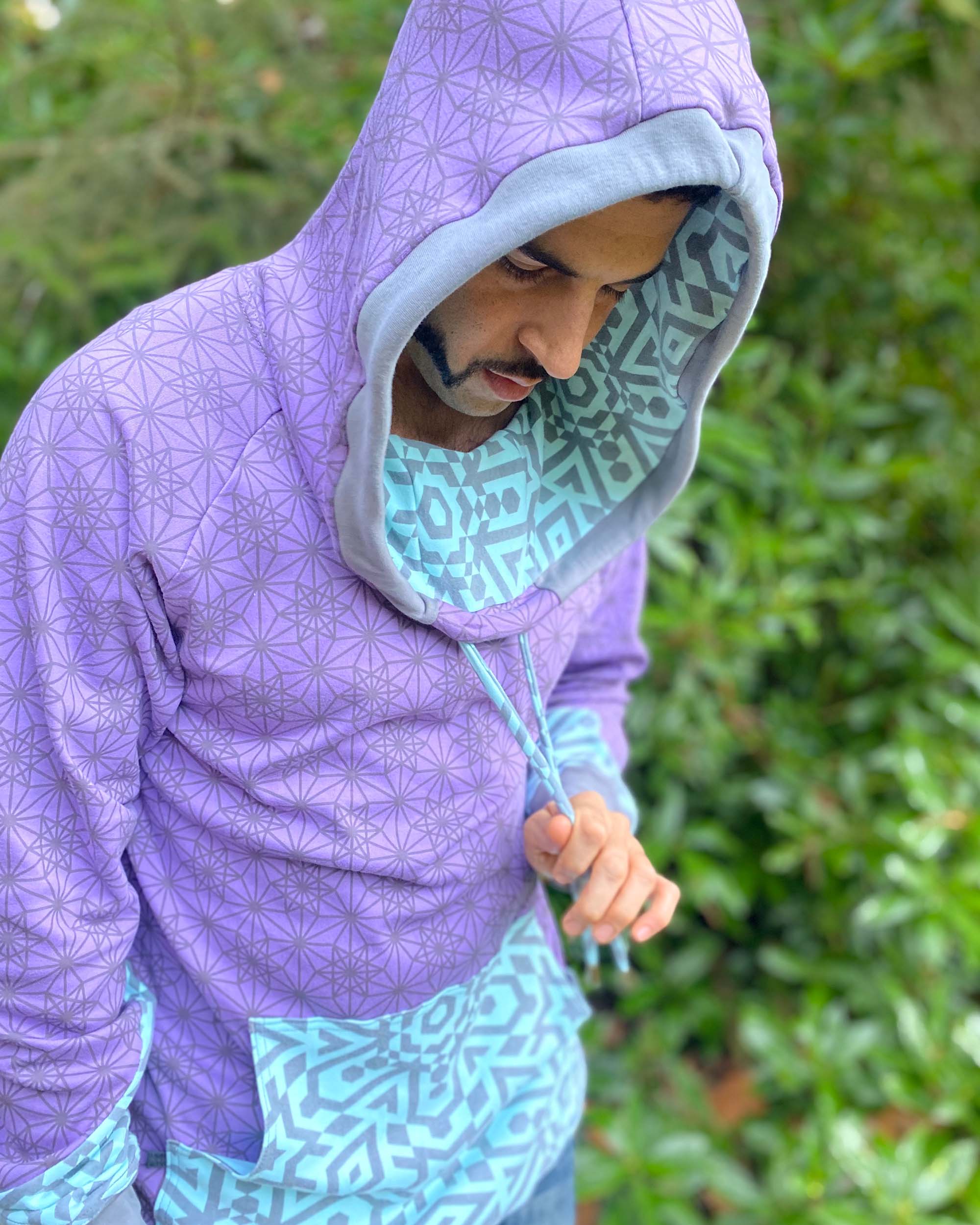 Organic cotton hoodie, lavender and blue fabric with geometric print, detail view on male model.