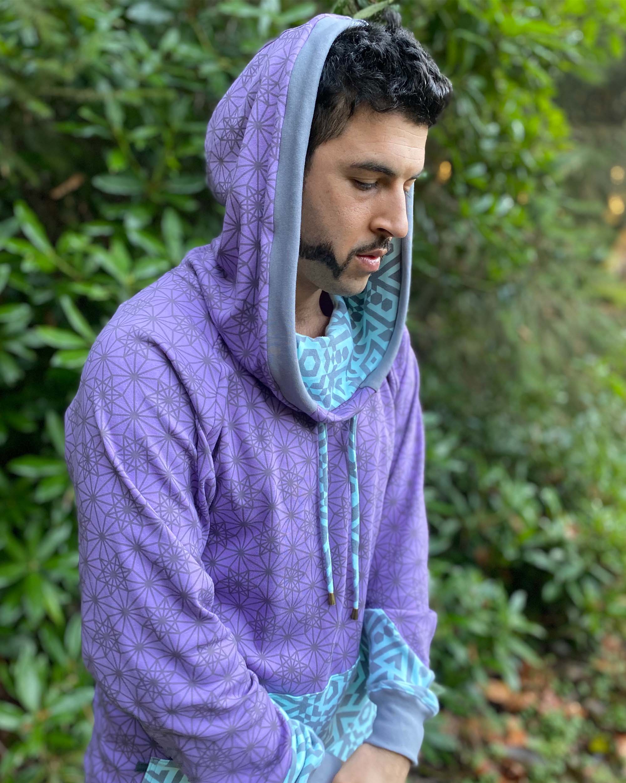 Organic cotton hoodie, lavender fabric with geo print, right side view on male model.