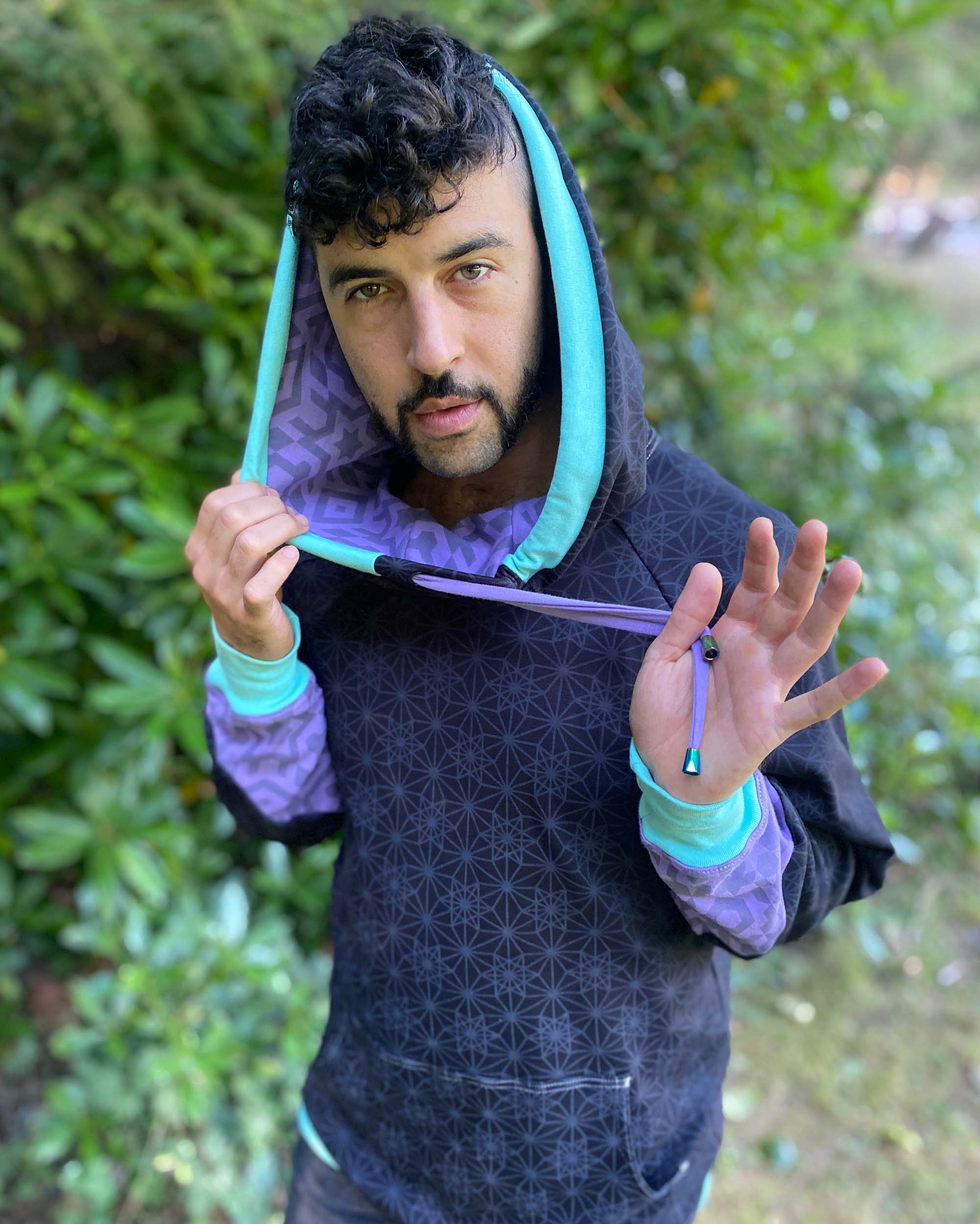 Organic cotton hoodie, black with sacred geometry print and lavender accents, detail view of hood.