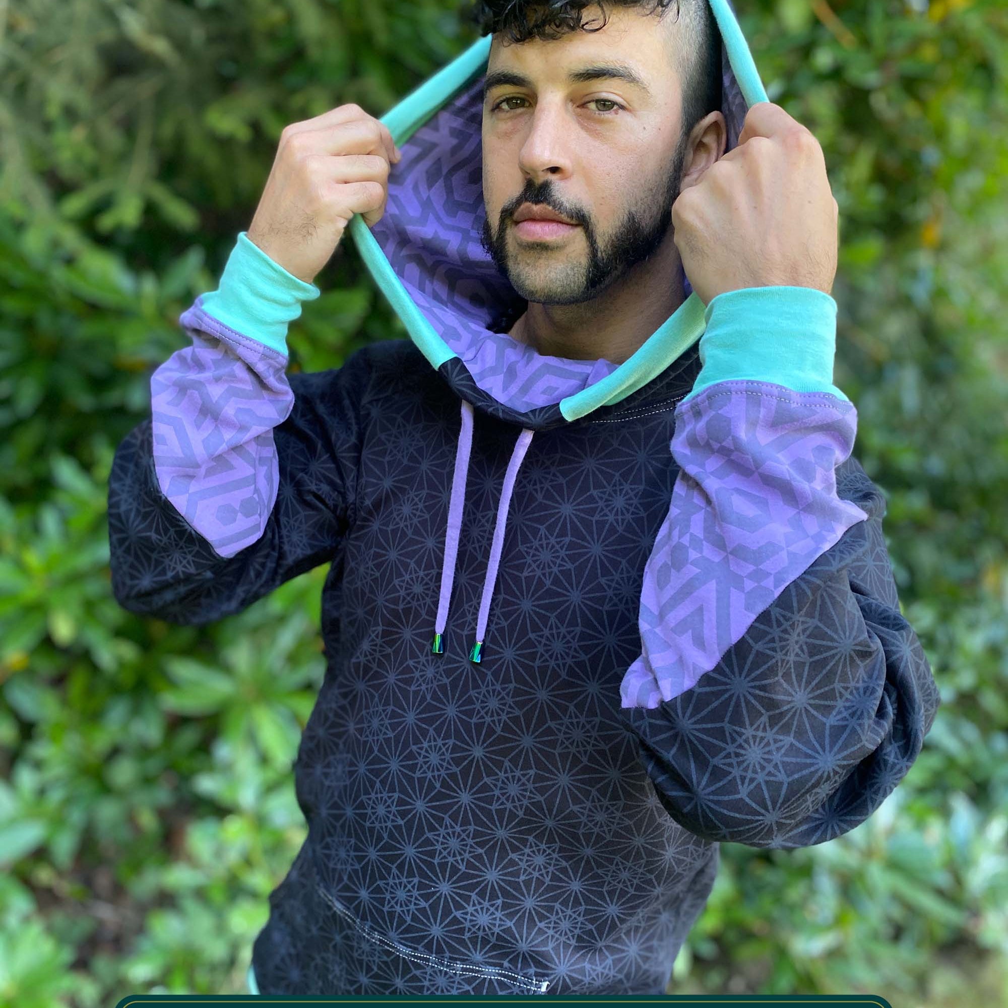 Organic cotton hoodie, black with sacred geometry print, front view worn by male model.