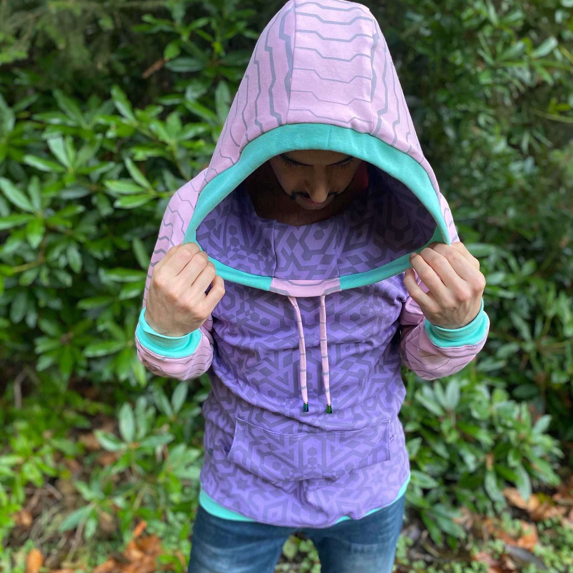 Organic cotton cowl hoodie, lavender and pink fabric with geo print, front view on male model.