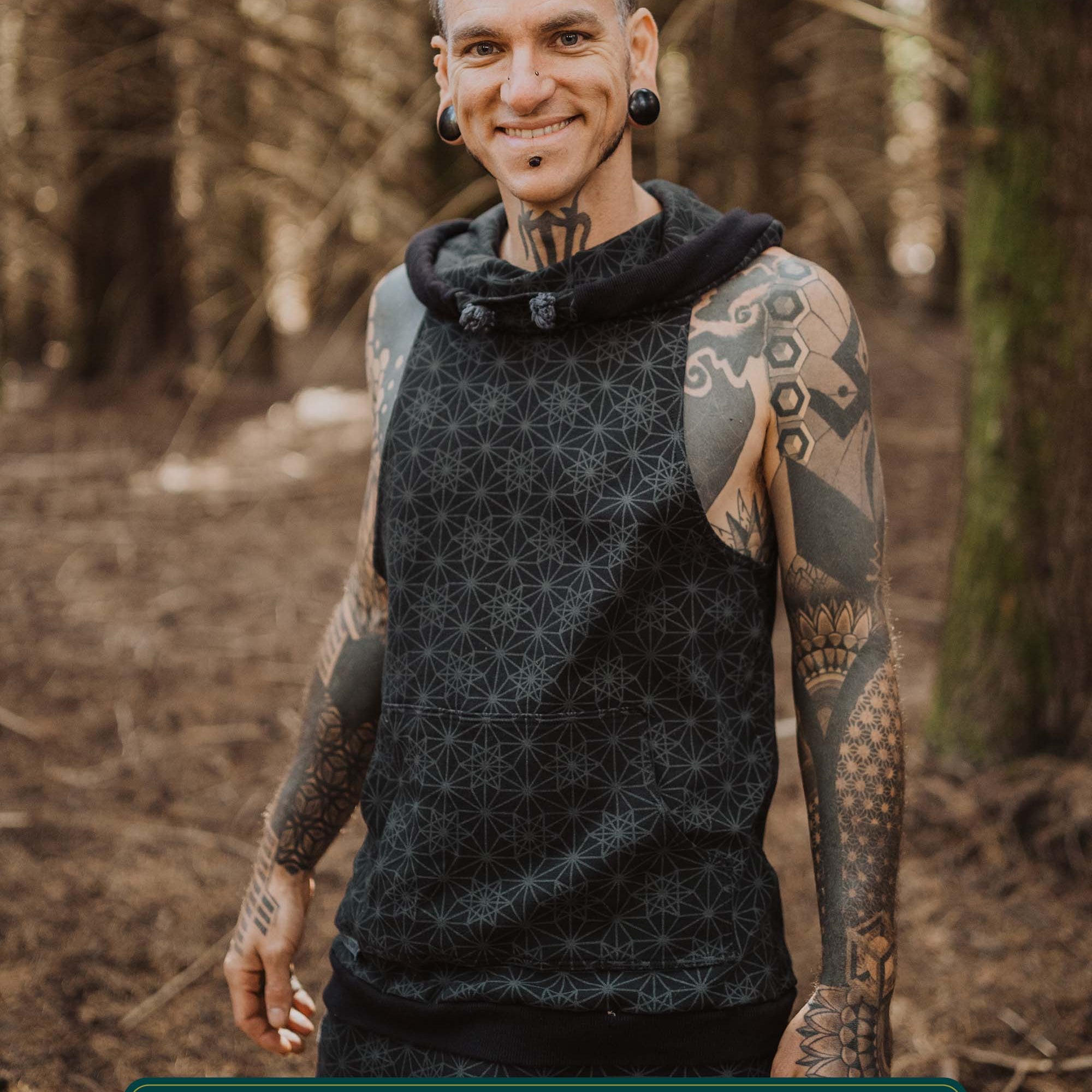 Organic cotton sleeveless hoodie, black with sacred geometry print, front view on male model.