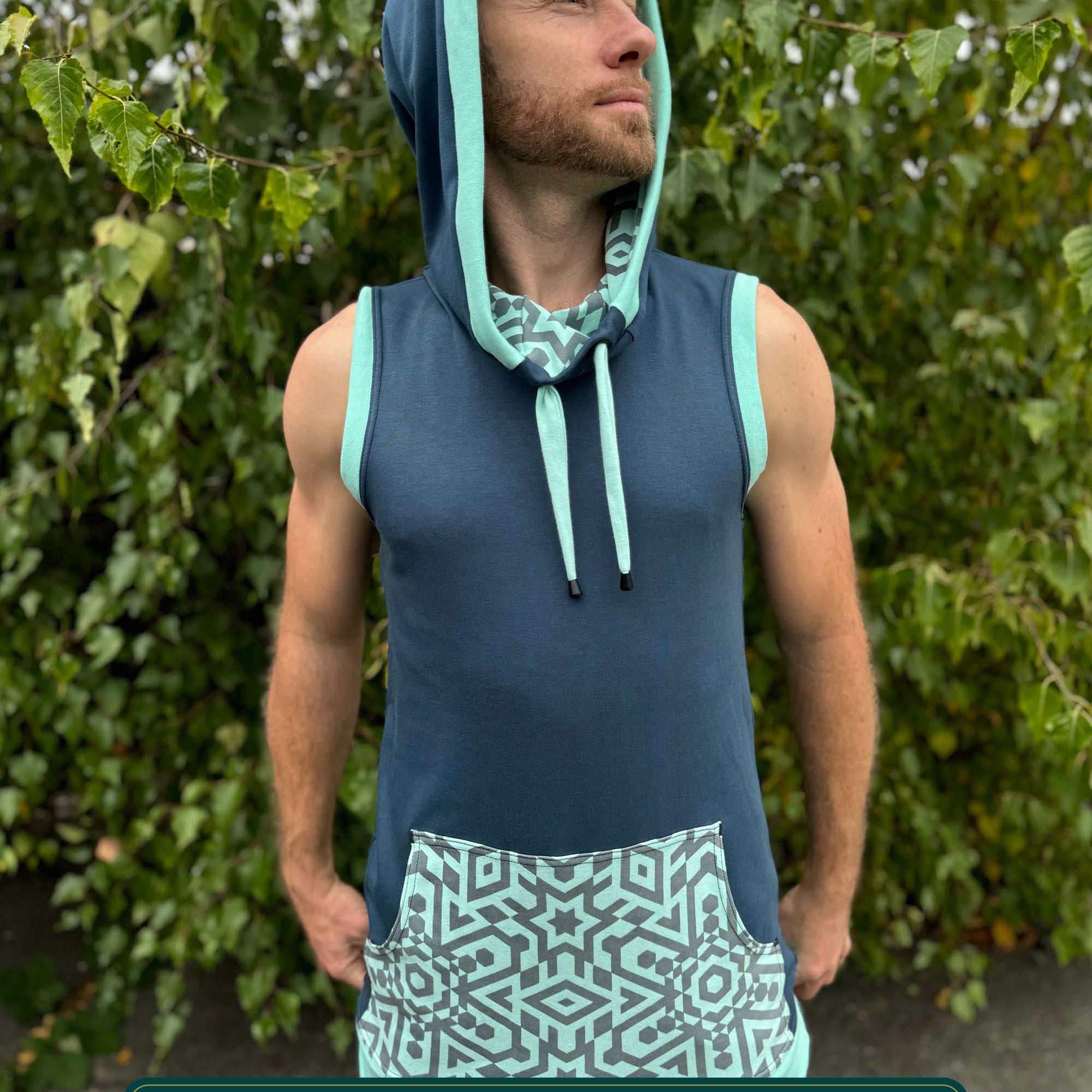 Organic cotton sleeveless hoodie, deep blue with mint geometric print accent fabric, front view on male model.