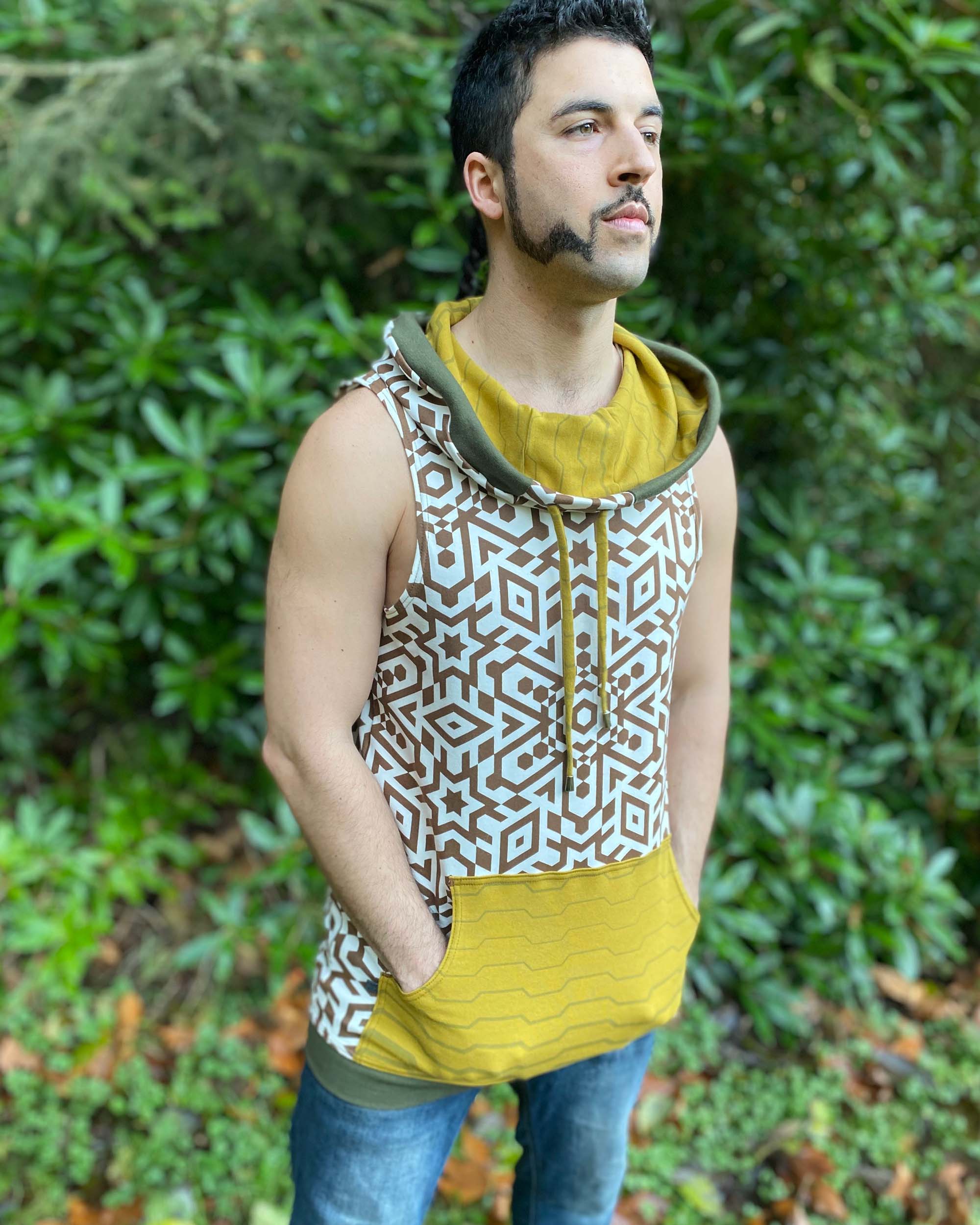 Organic cotton hooded tank top, undyed with brown geometric print, front side view on male model in nature.