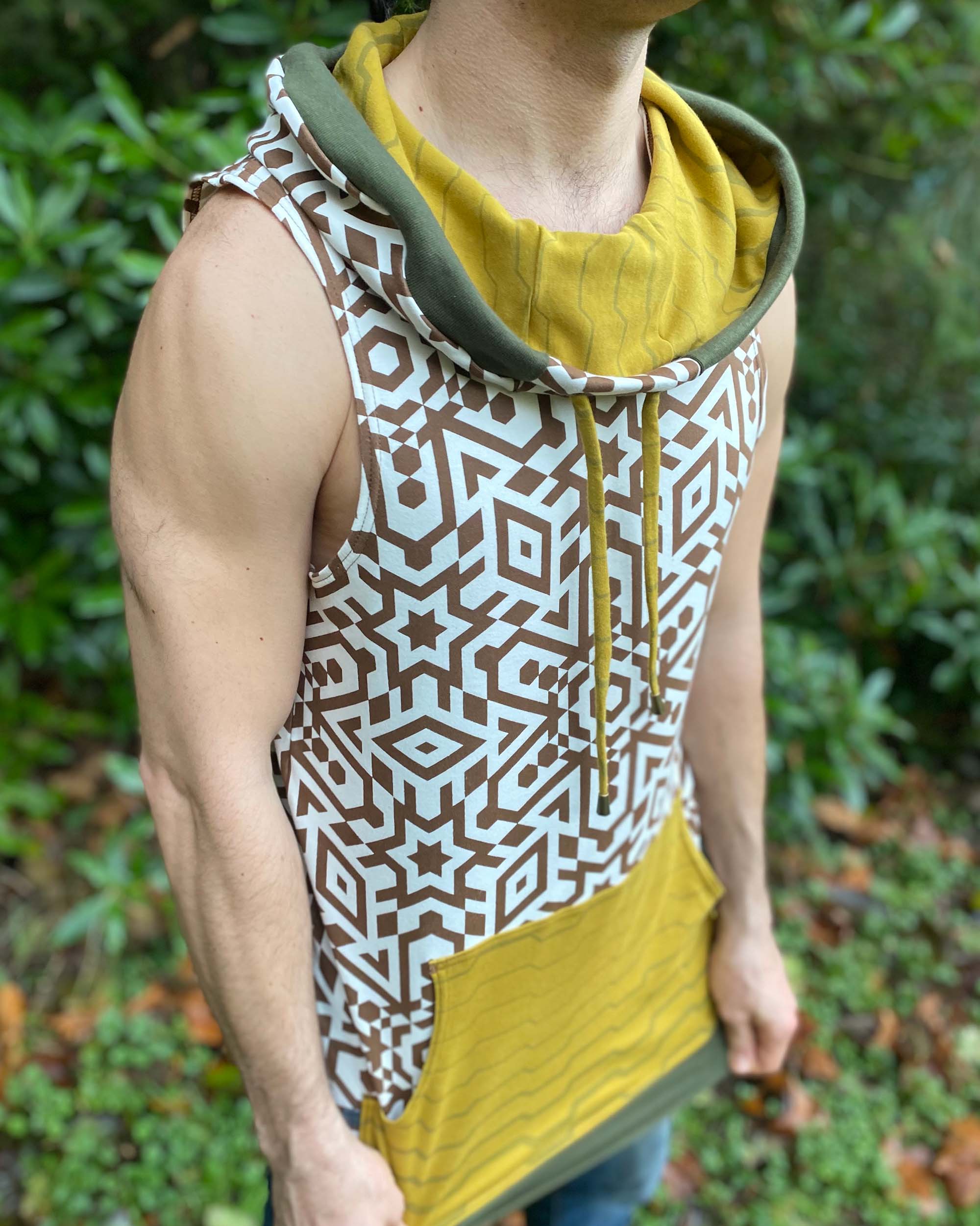 Organic cotton hooded tank top, undyed with brown geometric print, right side view on model.