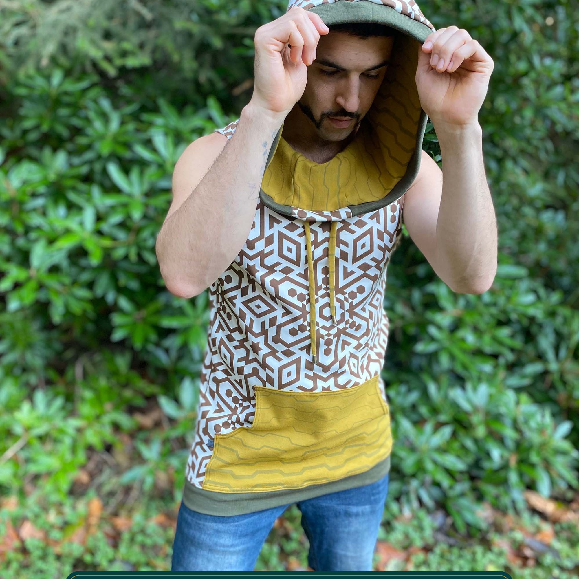 Organic cotton hooded tank top, undyed with brown geometric print, front side view on male model.
