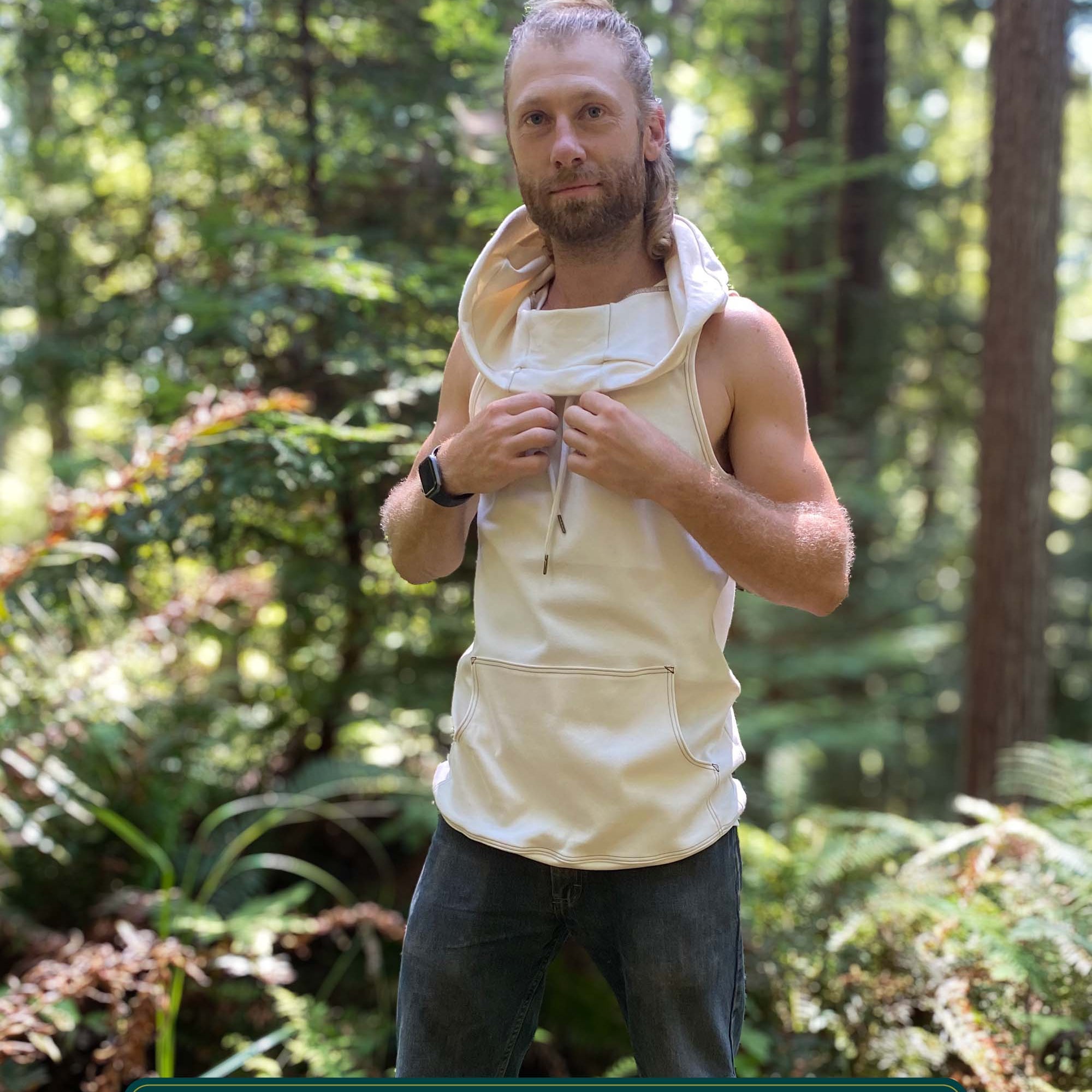 Organic cotton sleeveless hoodie, undyed fabric, front left side view on male model.
