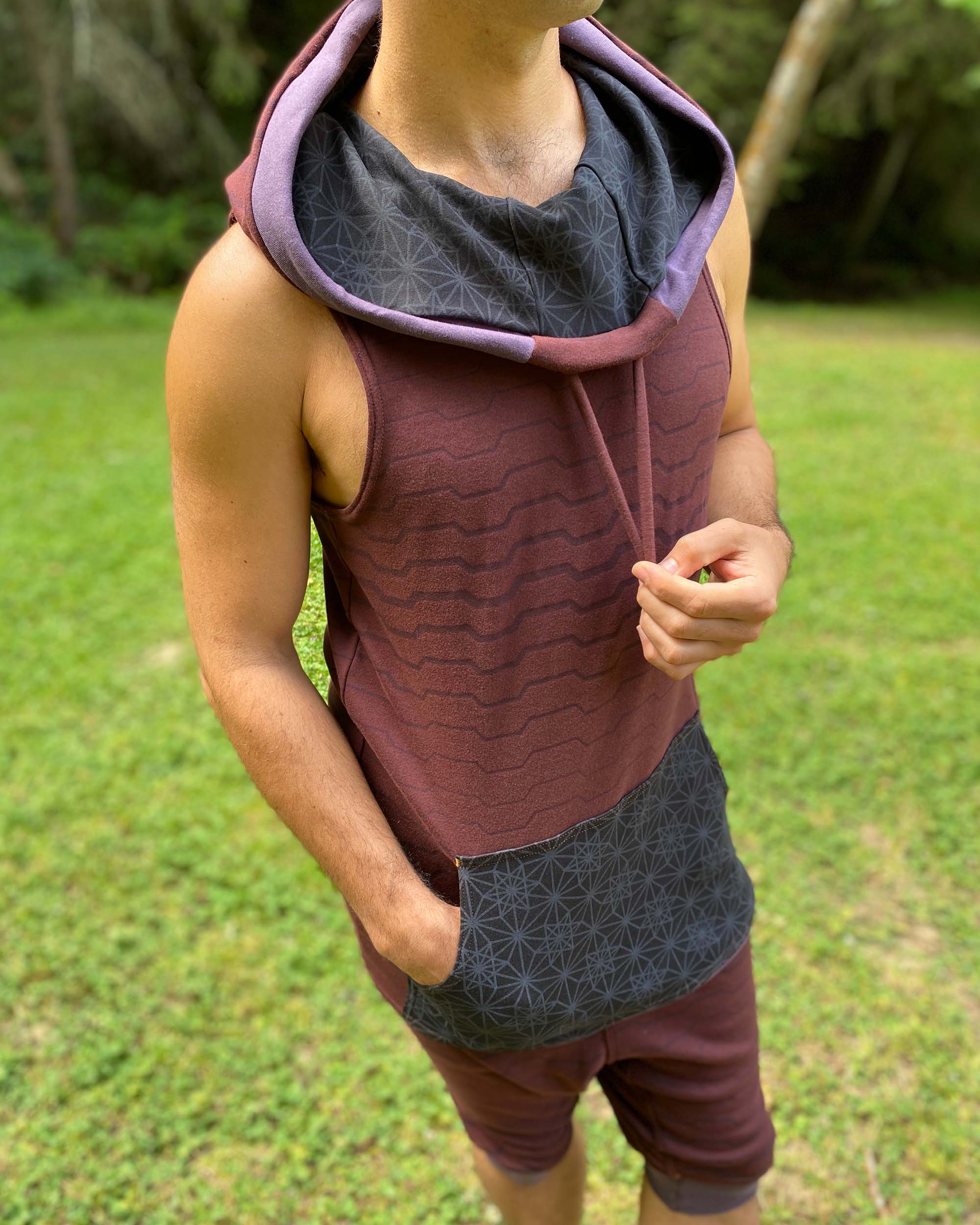 Organic cotton hooded tank top, brown with black accents and geo print, front close up view of fabric.