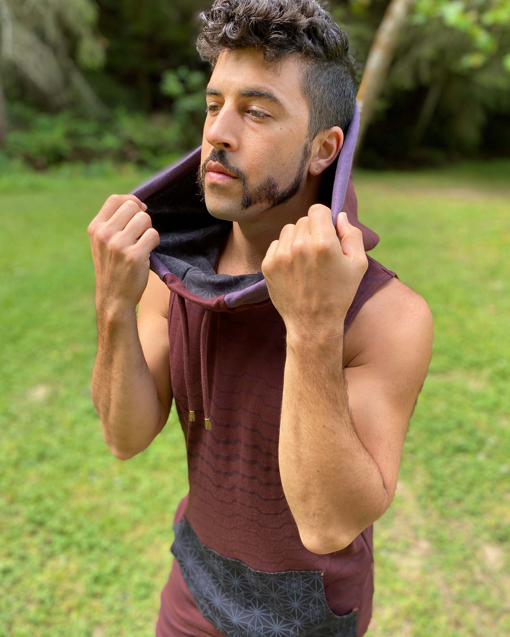 Organic cotton sleeveless hoodie, brown with black accents and geometric print, left side view.