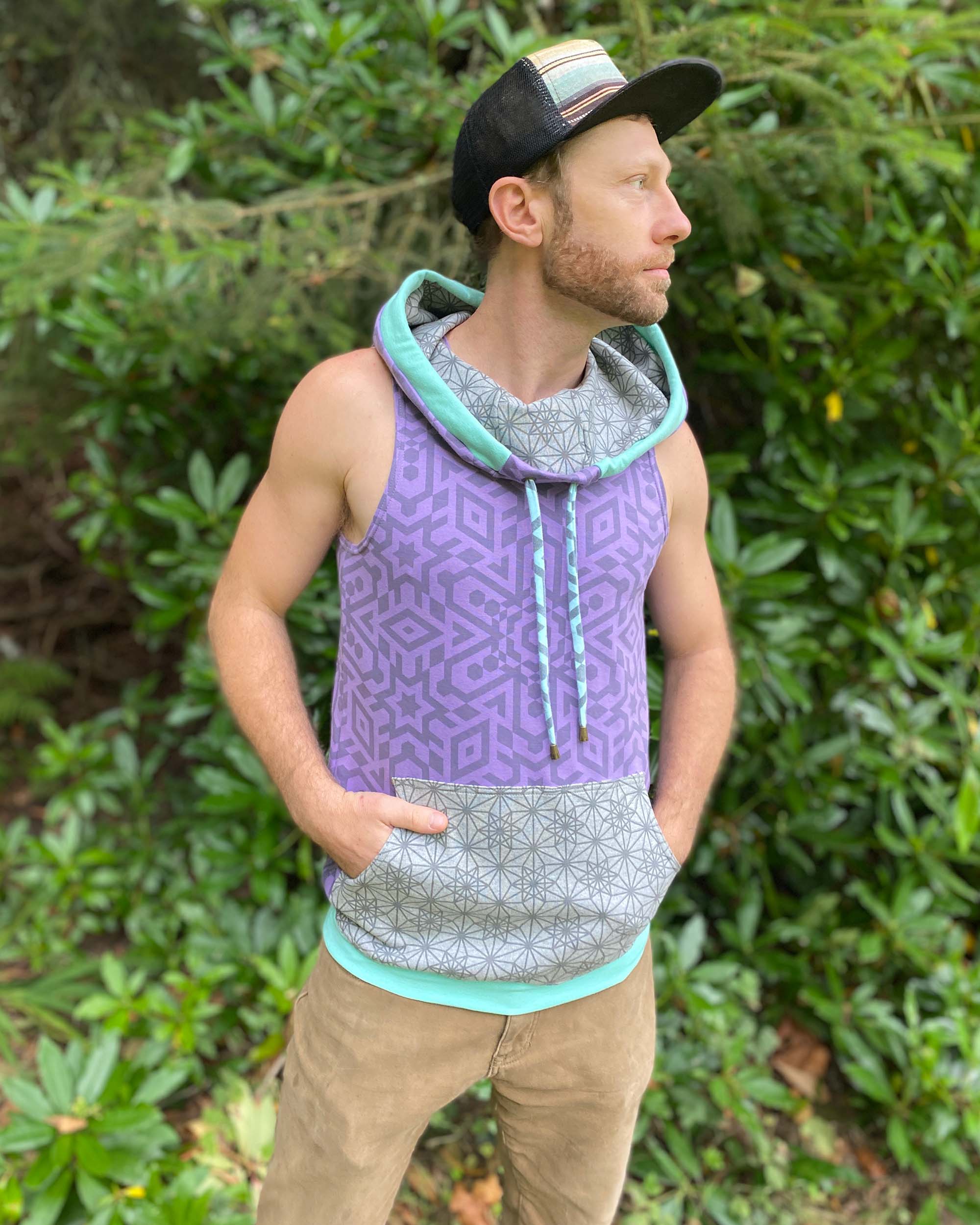 Organic cotton hooded tank top, lavender with geometric print fabric, front view on male model.