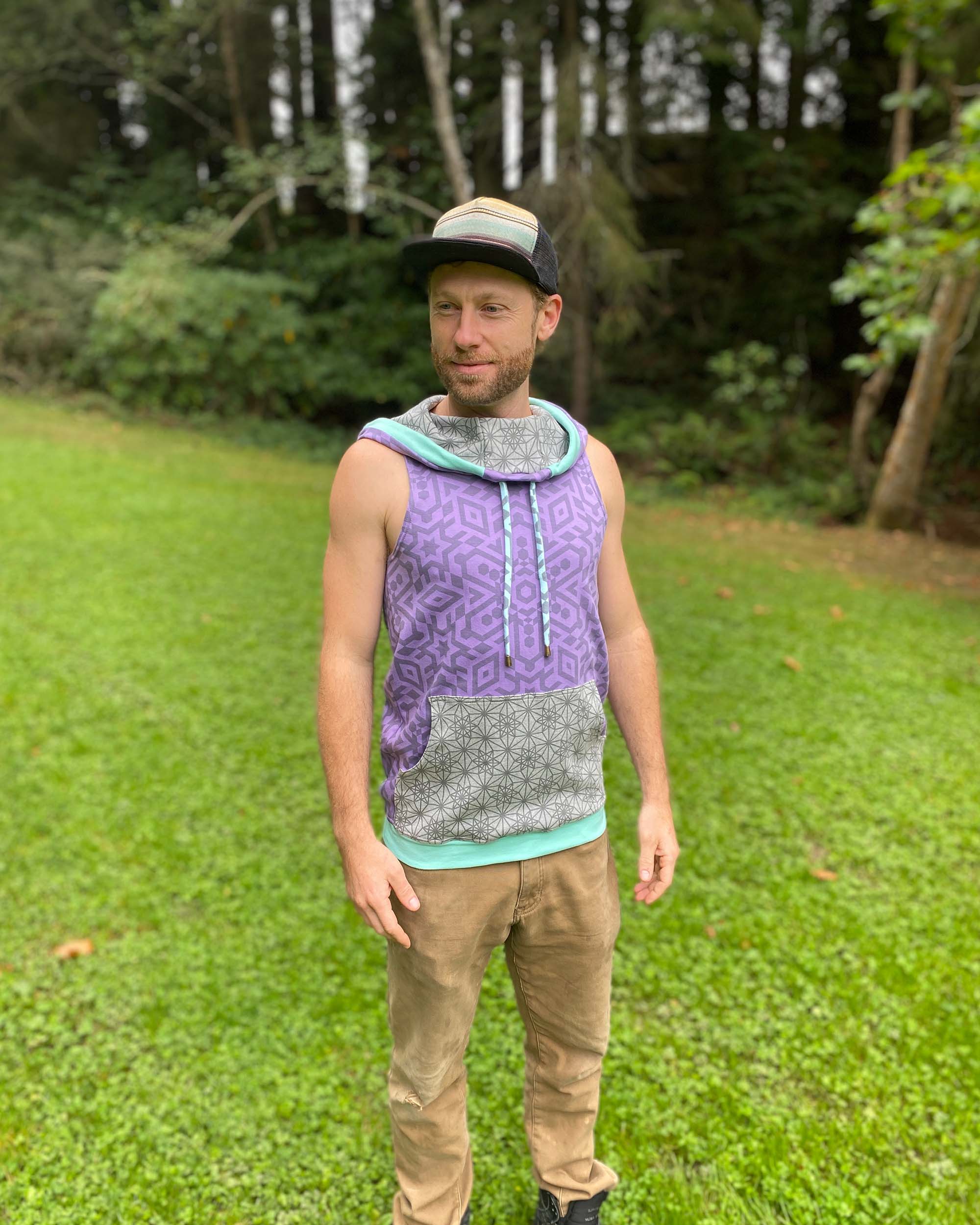 Organic cotton hooded tank top, lavender with geometric printed fabric, front view on male model.