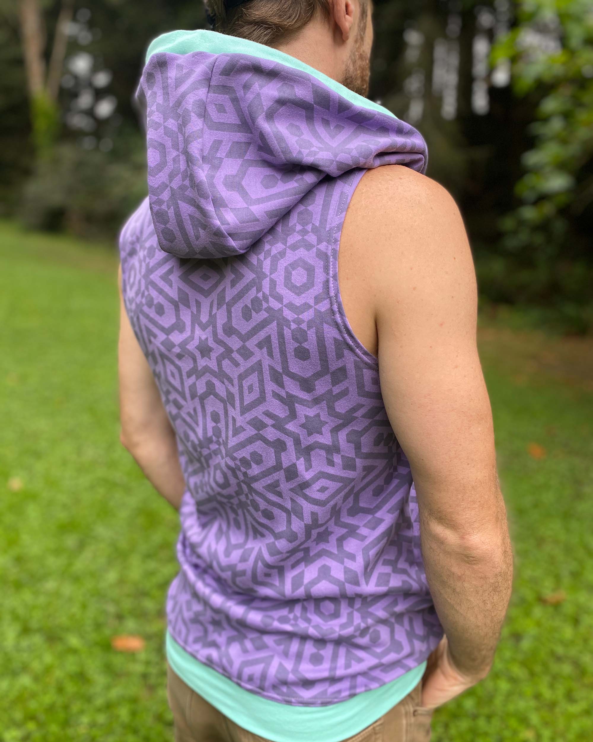 Organic cotton hooded tank top, lavender with geometric print, back side view on male model.