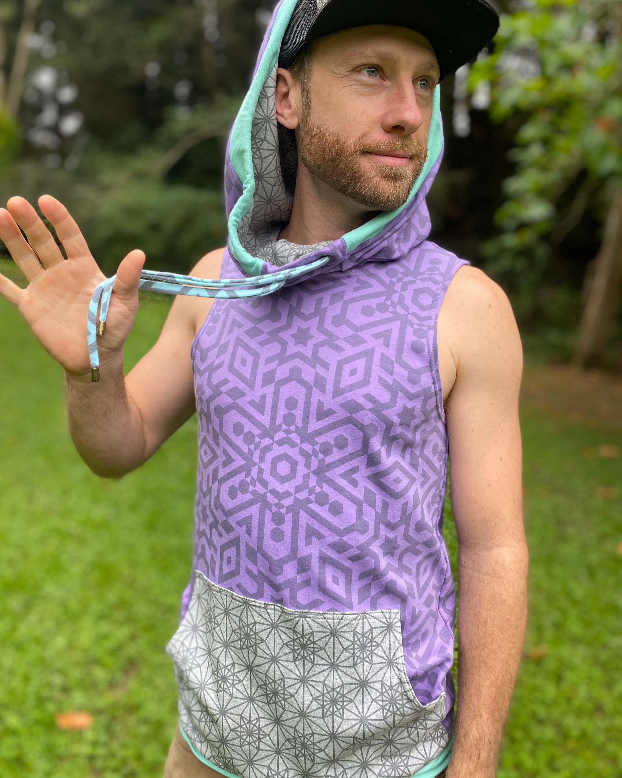 Organic cotton hooded tank top, lavender with sacred geometry print, front side view on male model.