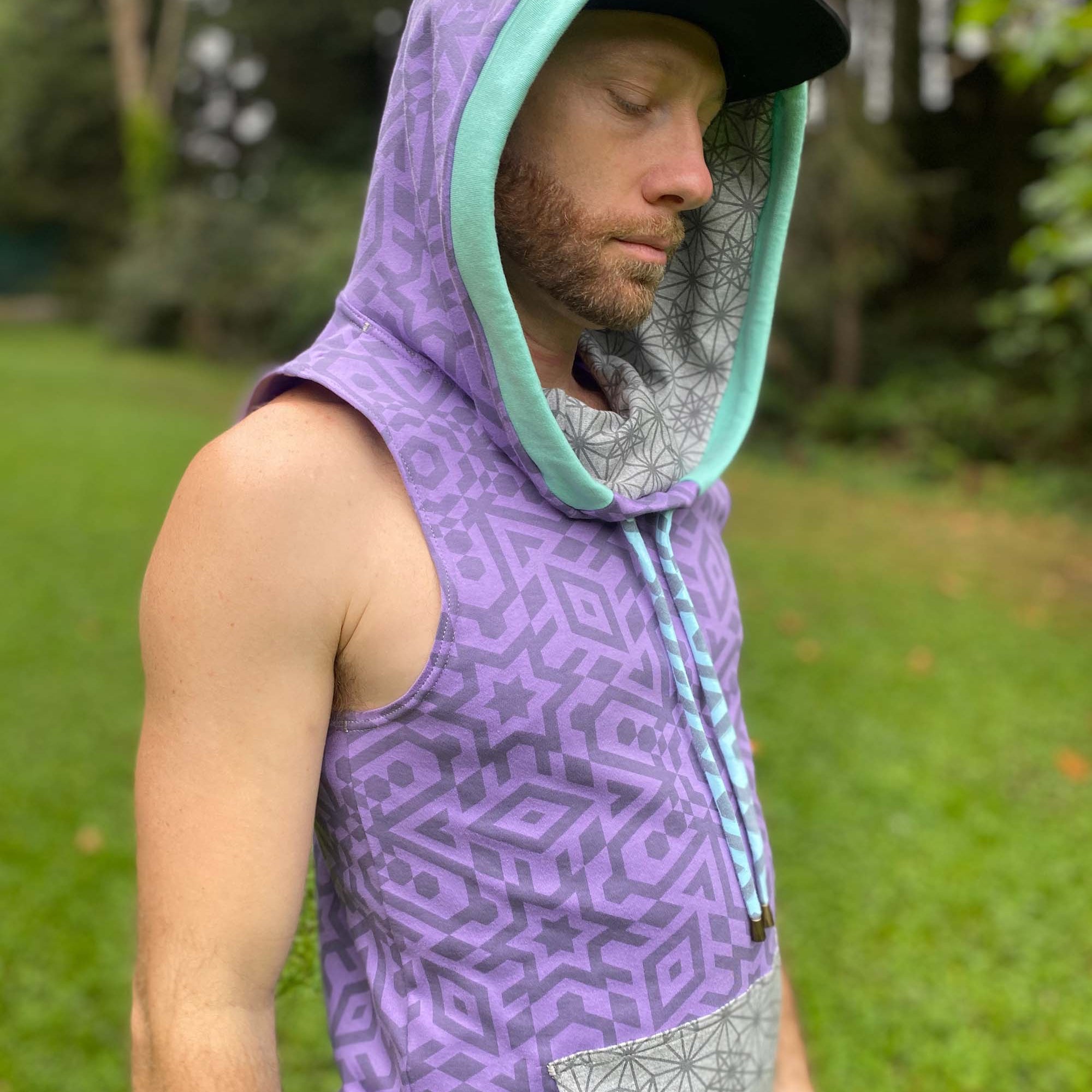 Organic cotton hooded tank top, lavender with geometric print, right side view on male model.