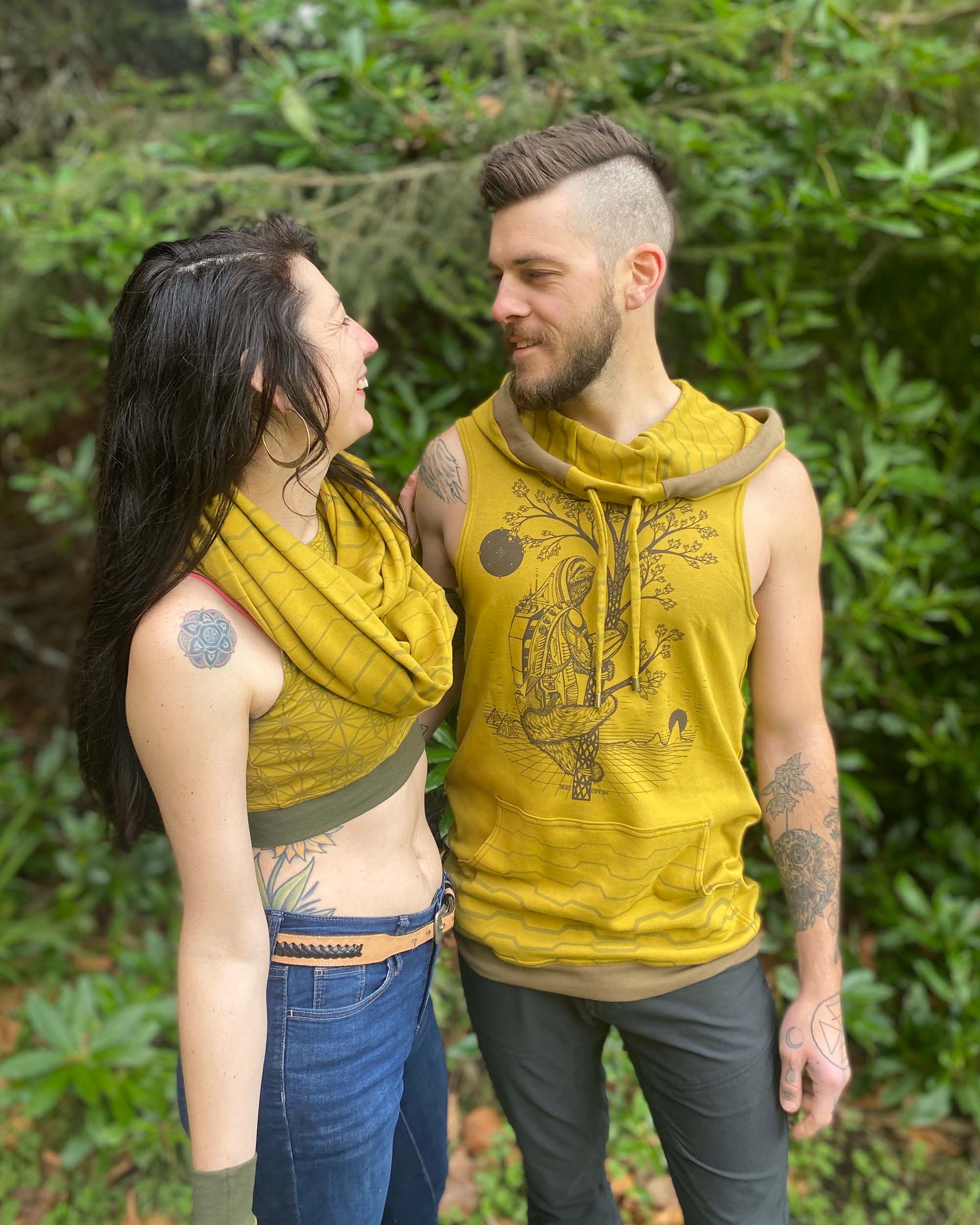 Organic cotton sleeveless hoodie, yellow fabric with sloth print, front side view on male model.