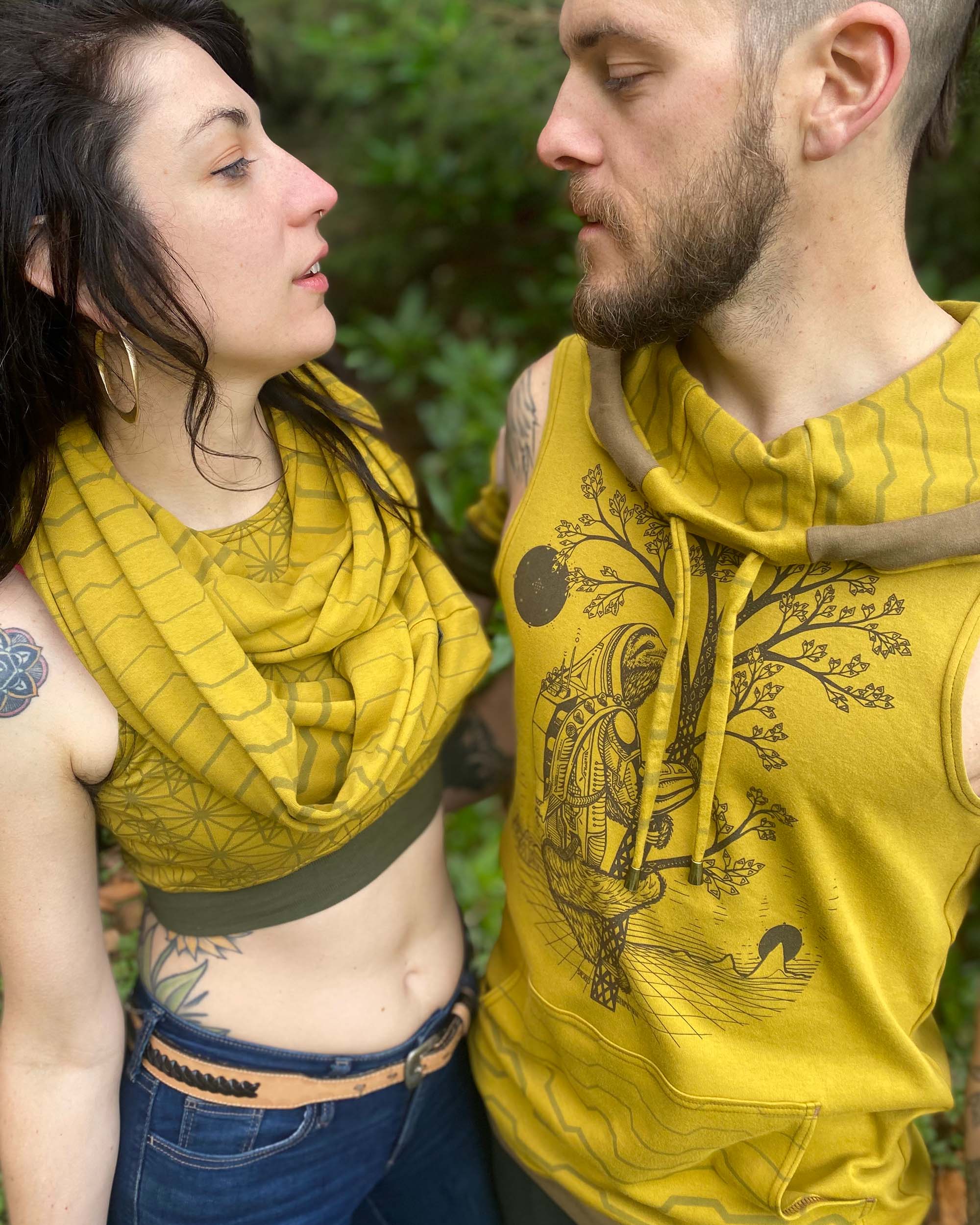 Organic cotton sleeveless hoodie, yellow fabric with sloth print, front detail view of fabric.