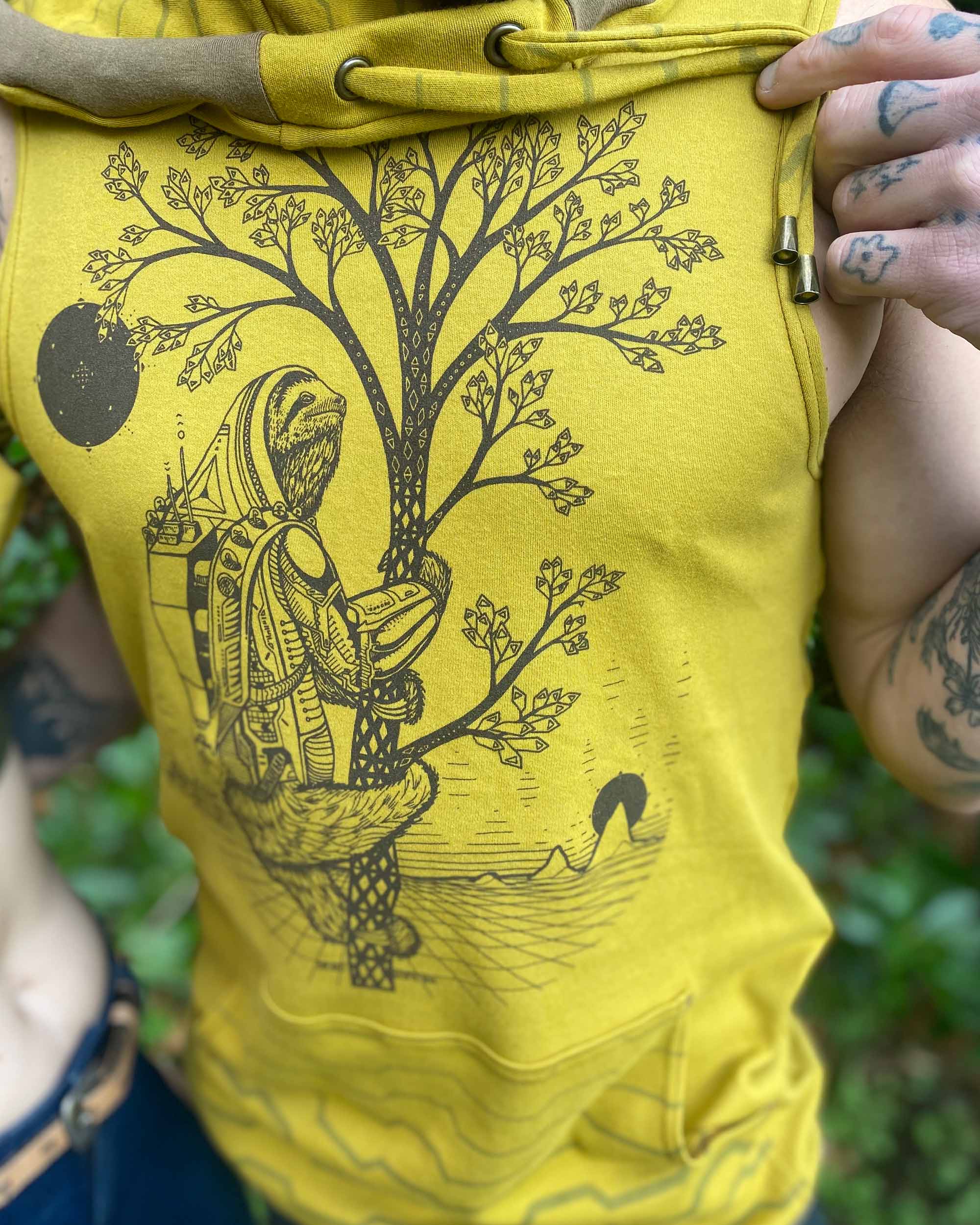 Organic cotton sleeveless hoodie, yellow fabric with sloth graphic, close up view of screen print.
