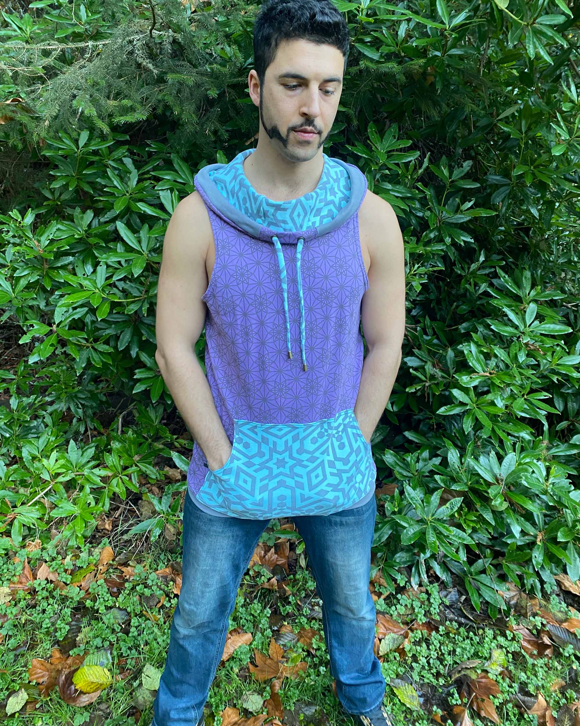 Organic cotton hooded tank top, lavender and mint fabric with geometric print, front view of male model.