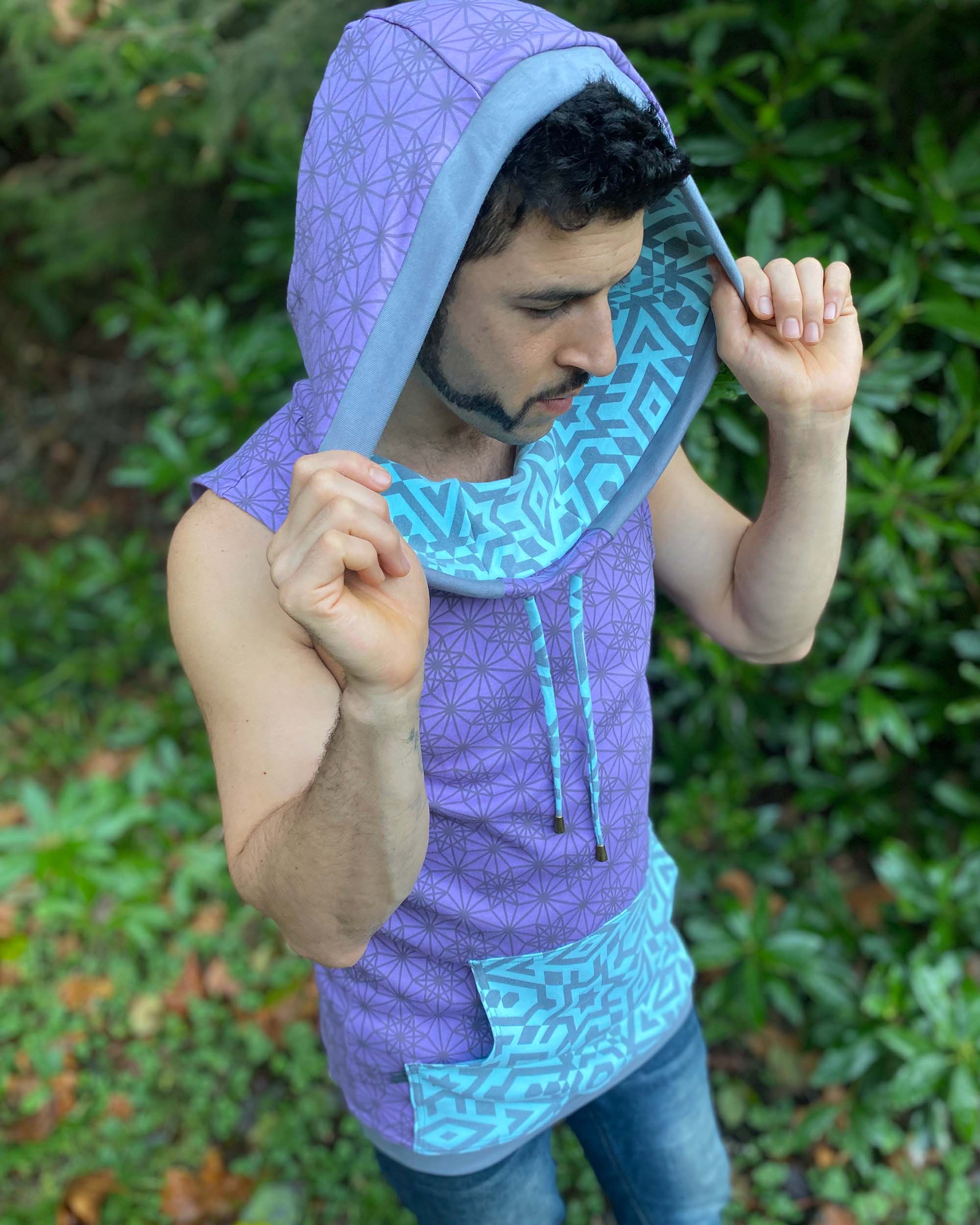 Organic cotton hooded tank top, lavender and mint fabric with geometric print, right top view of male model.
