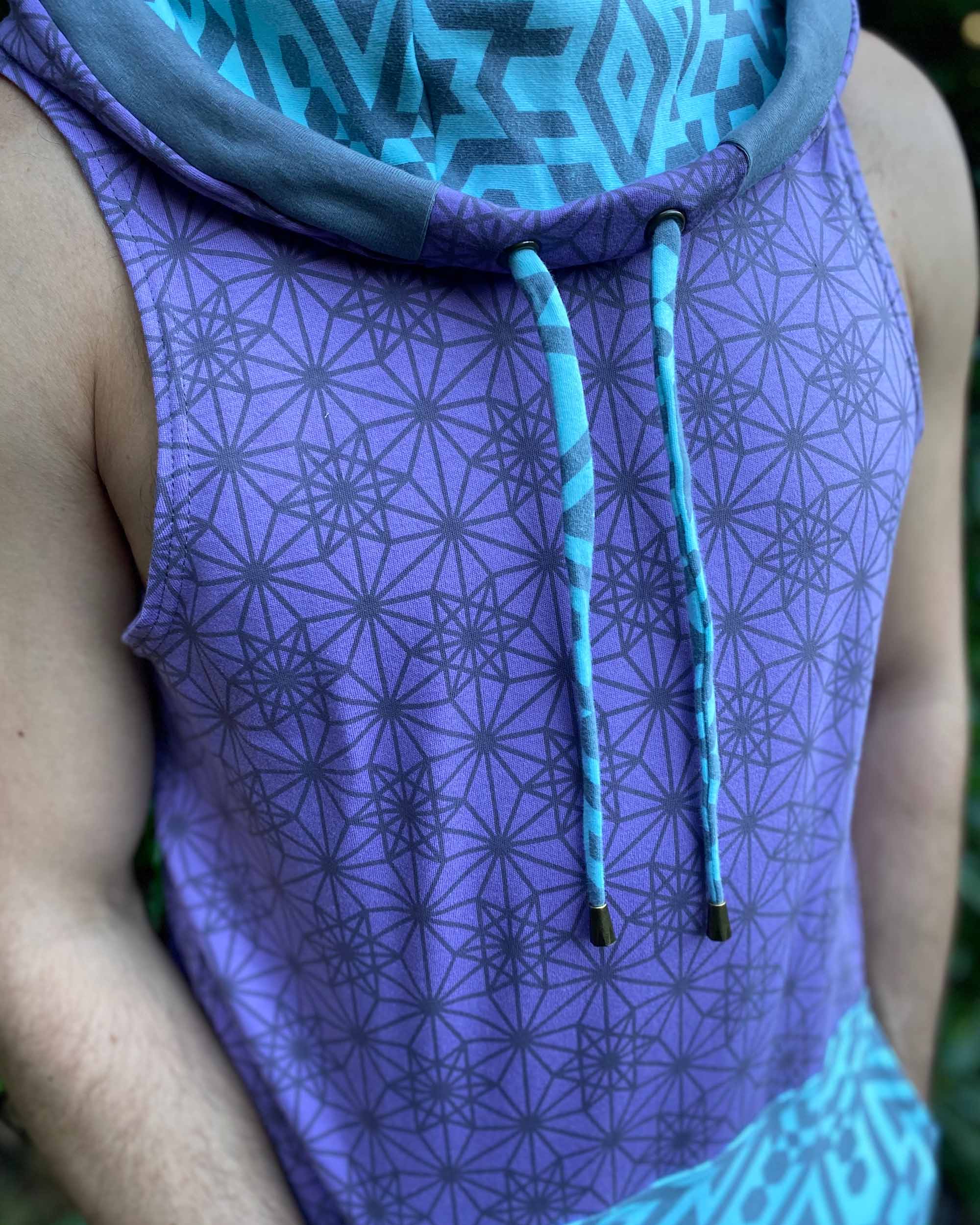 Organic cotton hooded tank top, lavender and mint fabric with geometric print, detail view of fabric.