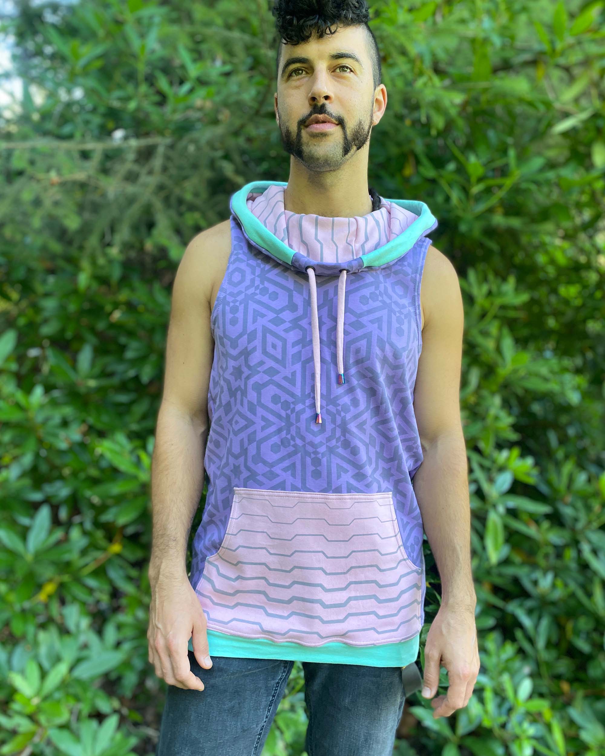 Organic cotton hooded tank top, lavender and pink geometric printed fabric, front side view on male model.