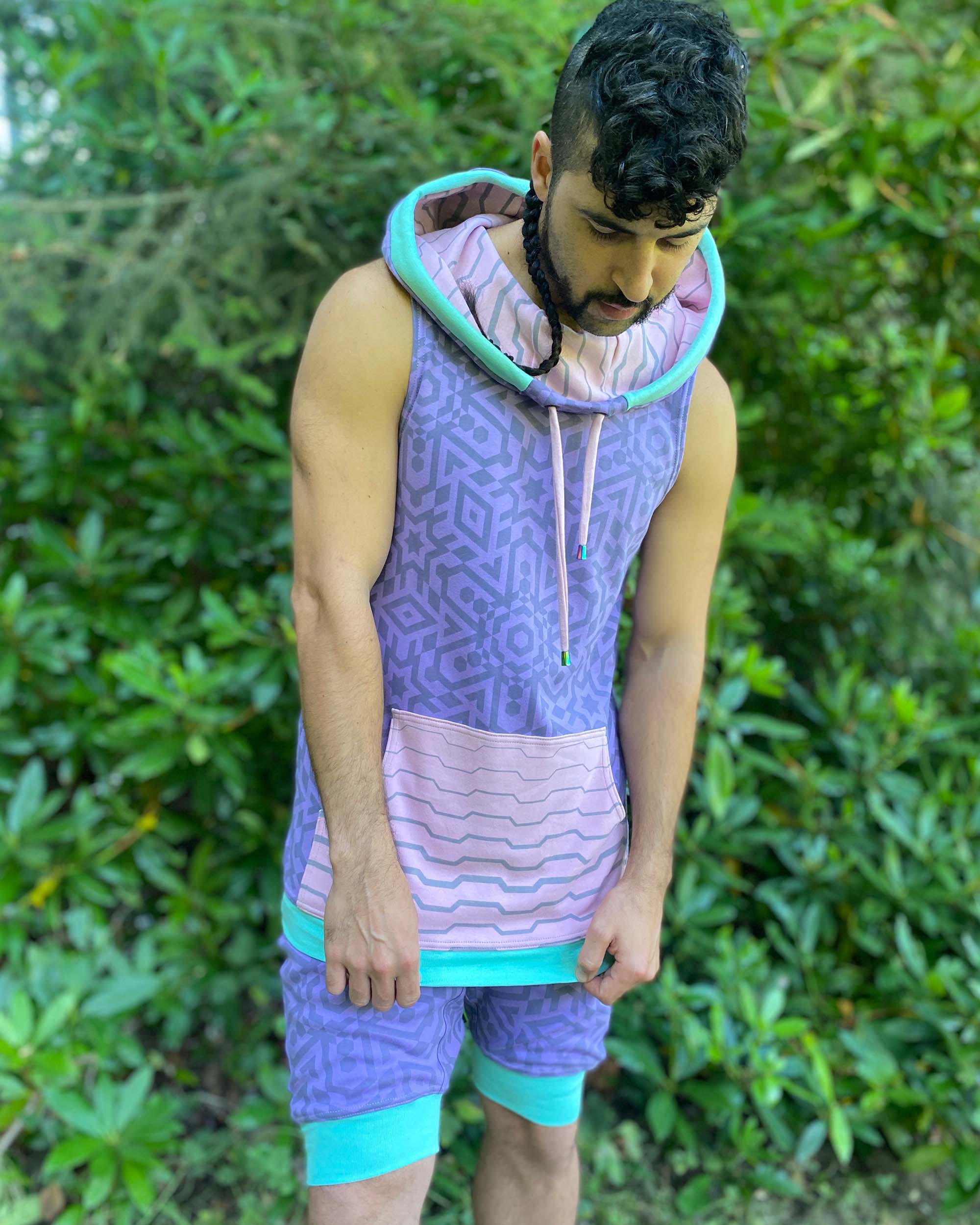 Organic cotton hooded tank top, lavender and pink geometric printed fabric, front side view on male model.