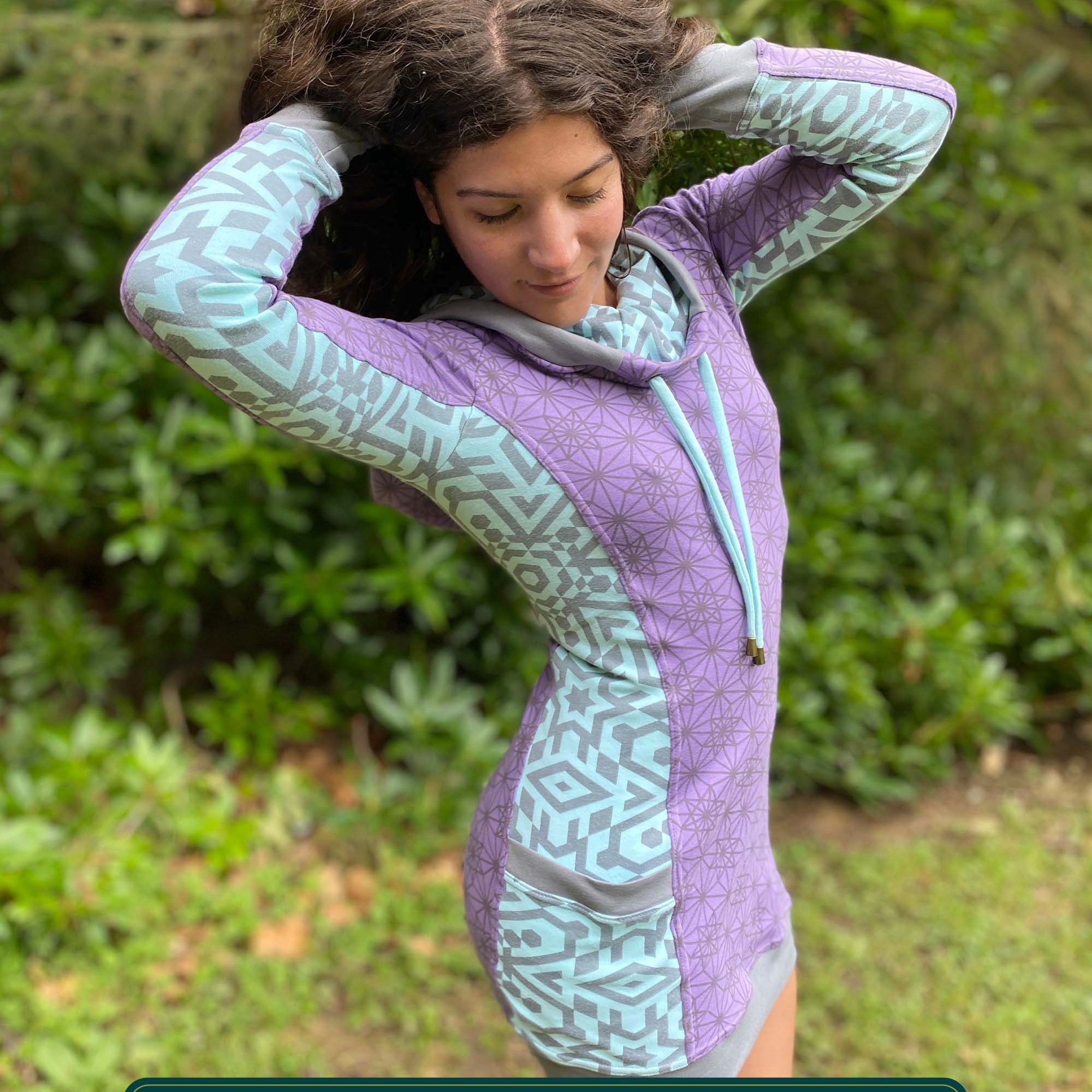 Organic cotton hooded tunic dress, lavender with geometric mint fabric accents, right side view on model.