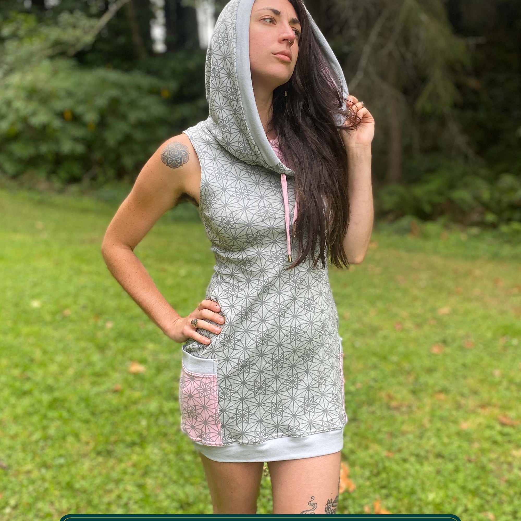Organic cotton sleeveless tunic dress, grey fabric with geo print, front view on female model.