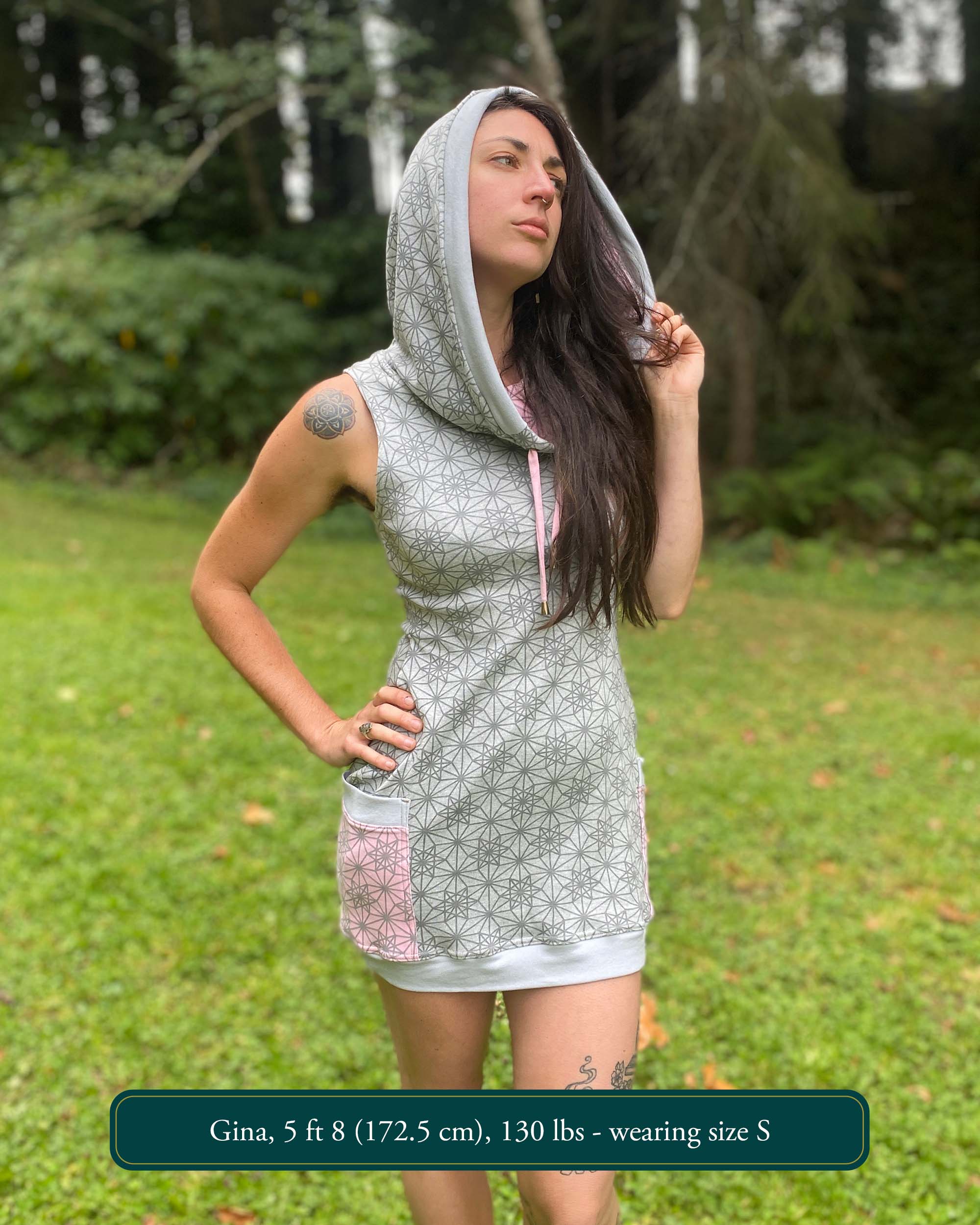Organic cotton sleeveless tunic dress, grey fabric with geo print, front view on female model.