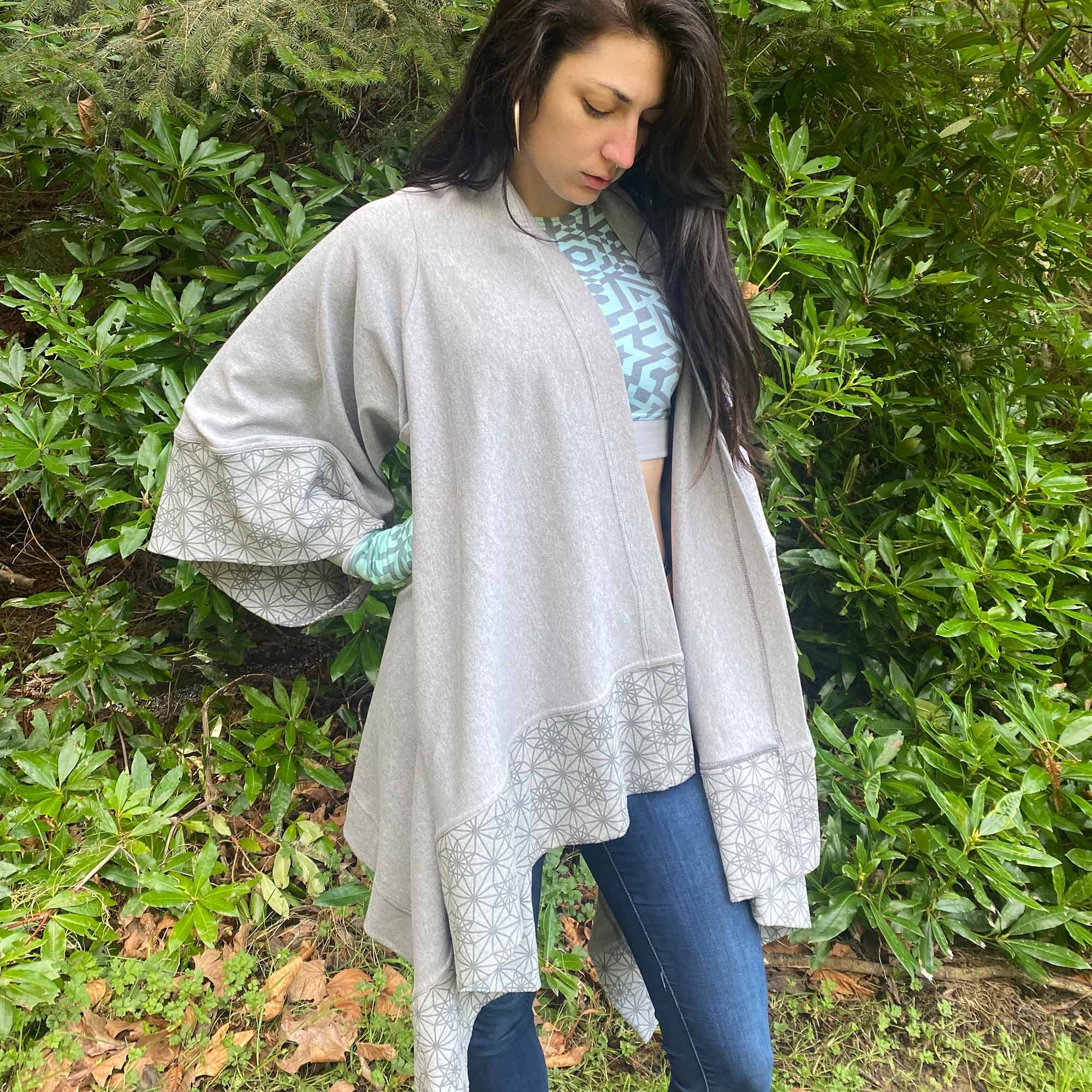 Organic cotton kimono, grey fabric with geometric print accents, front view on female model in natural lighting.