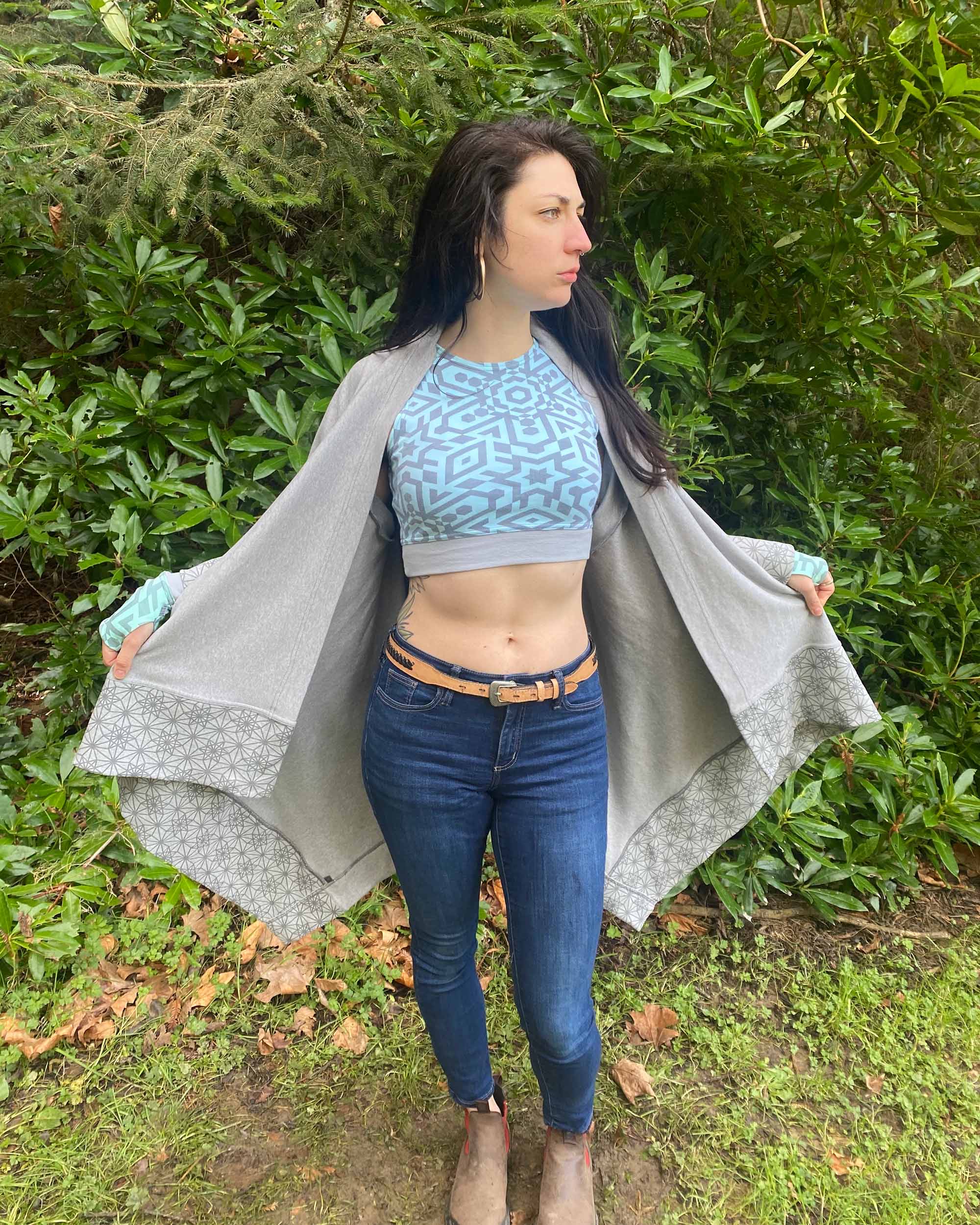 Organic cotton kimono, grey fabric with grey geo print accents, front view on female model in nature.