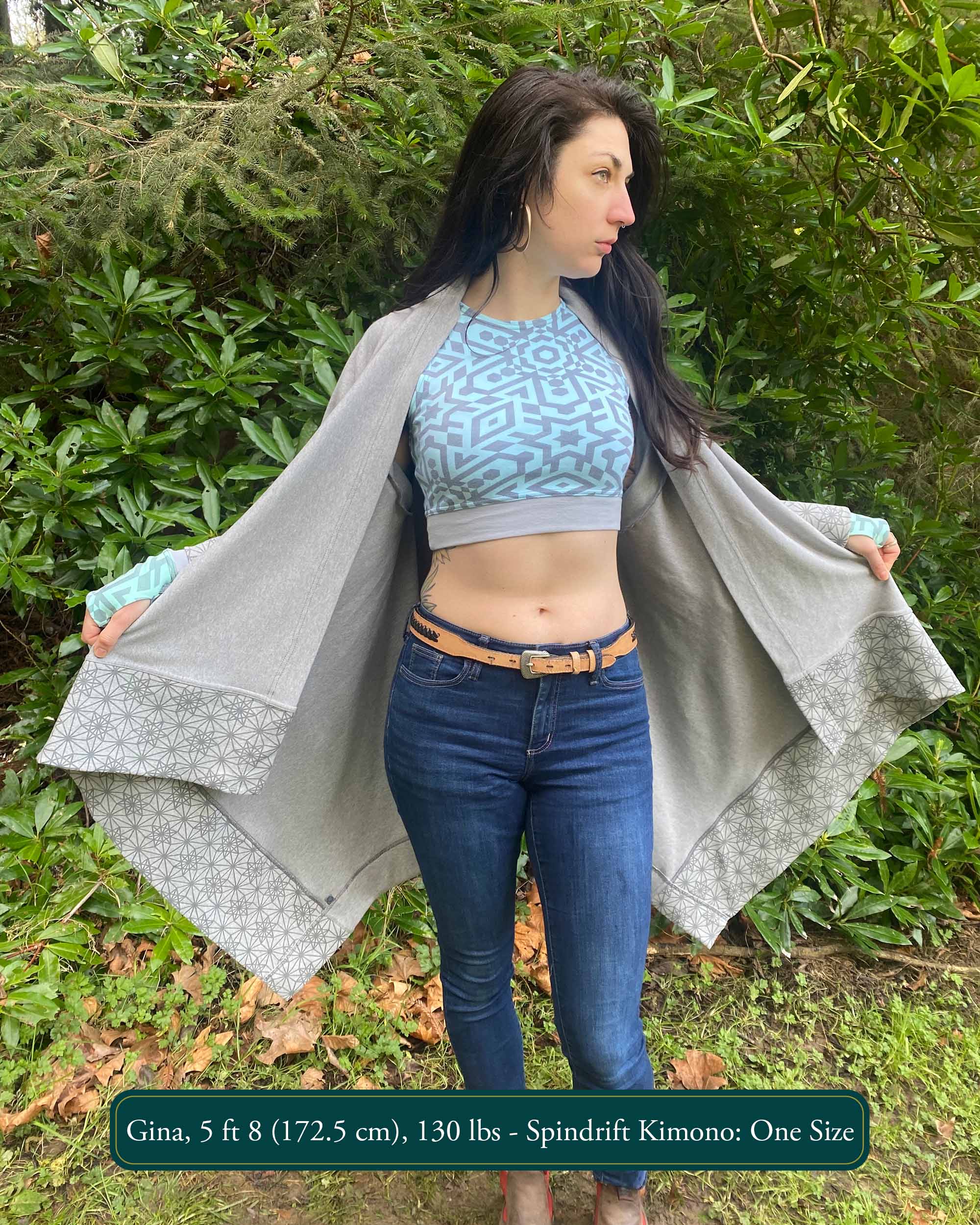 Organic cotton kimono, grey fabric with geometric print accents, front view on female model in nature.